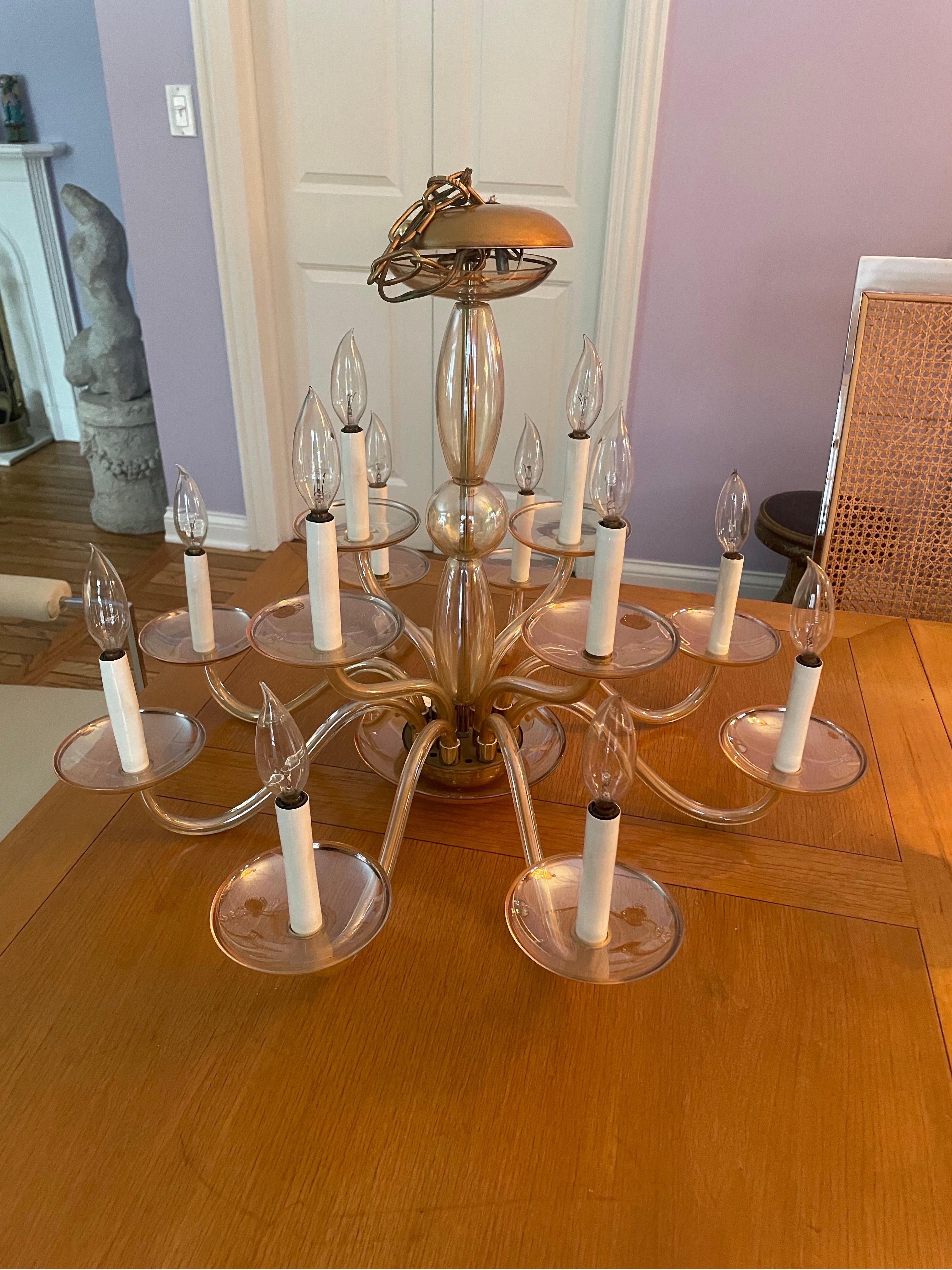 This is a beautiful vintage Murano
Glass 12 arm chandelier. The glass has a slight iridescent gold hue to the glass.  It’s in wonderful vintage condition, no chips or cracks to glass 