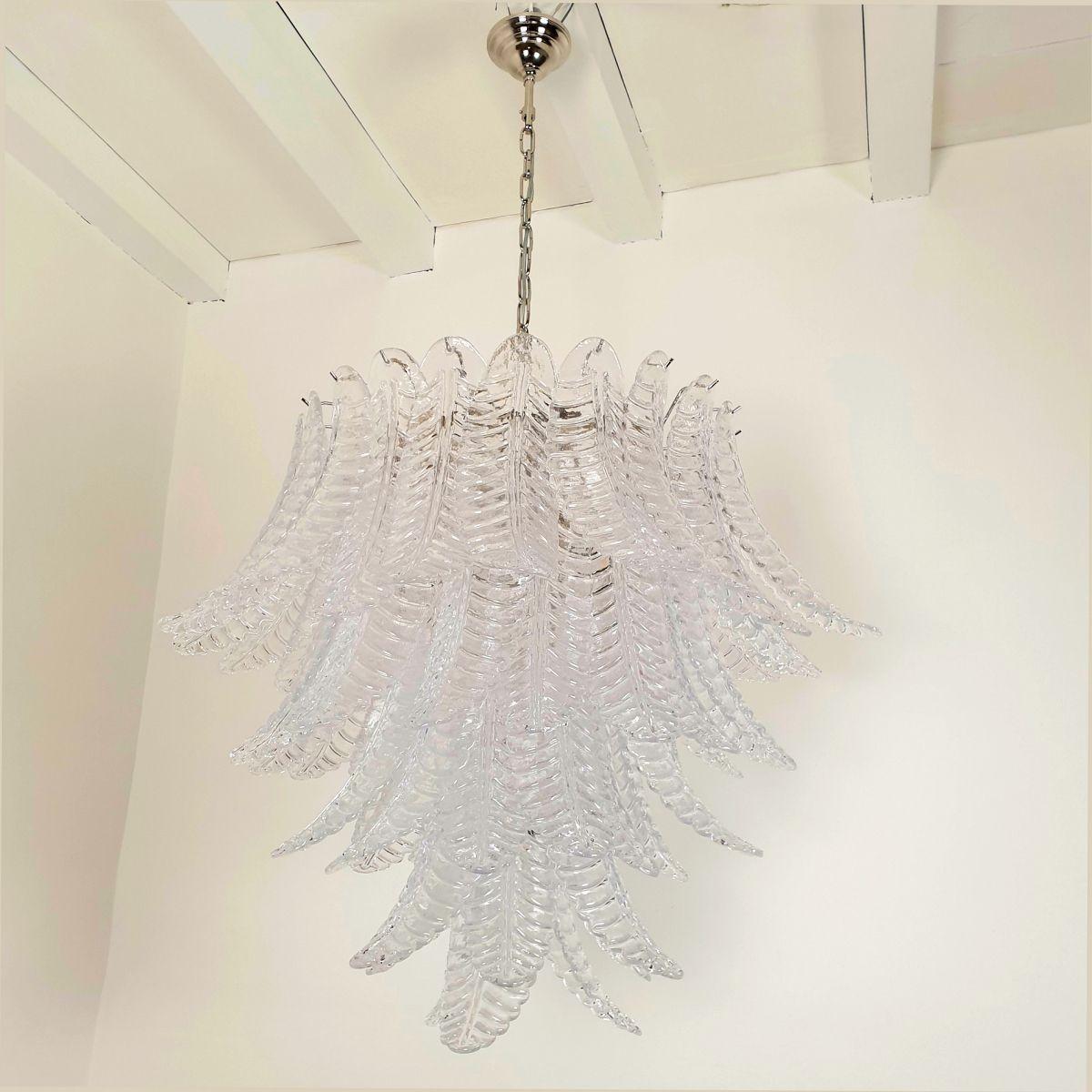 Large Mid Century Modern Murano glass chandelier, attributed to Mazzega, Italy 1970s.
The vintage chandelier is made of transparent Murano glass leaves and a chrome frame.
The Murano glass leaves are translucent.
The glasses are hand blown with a