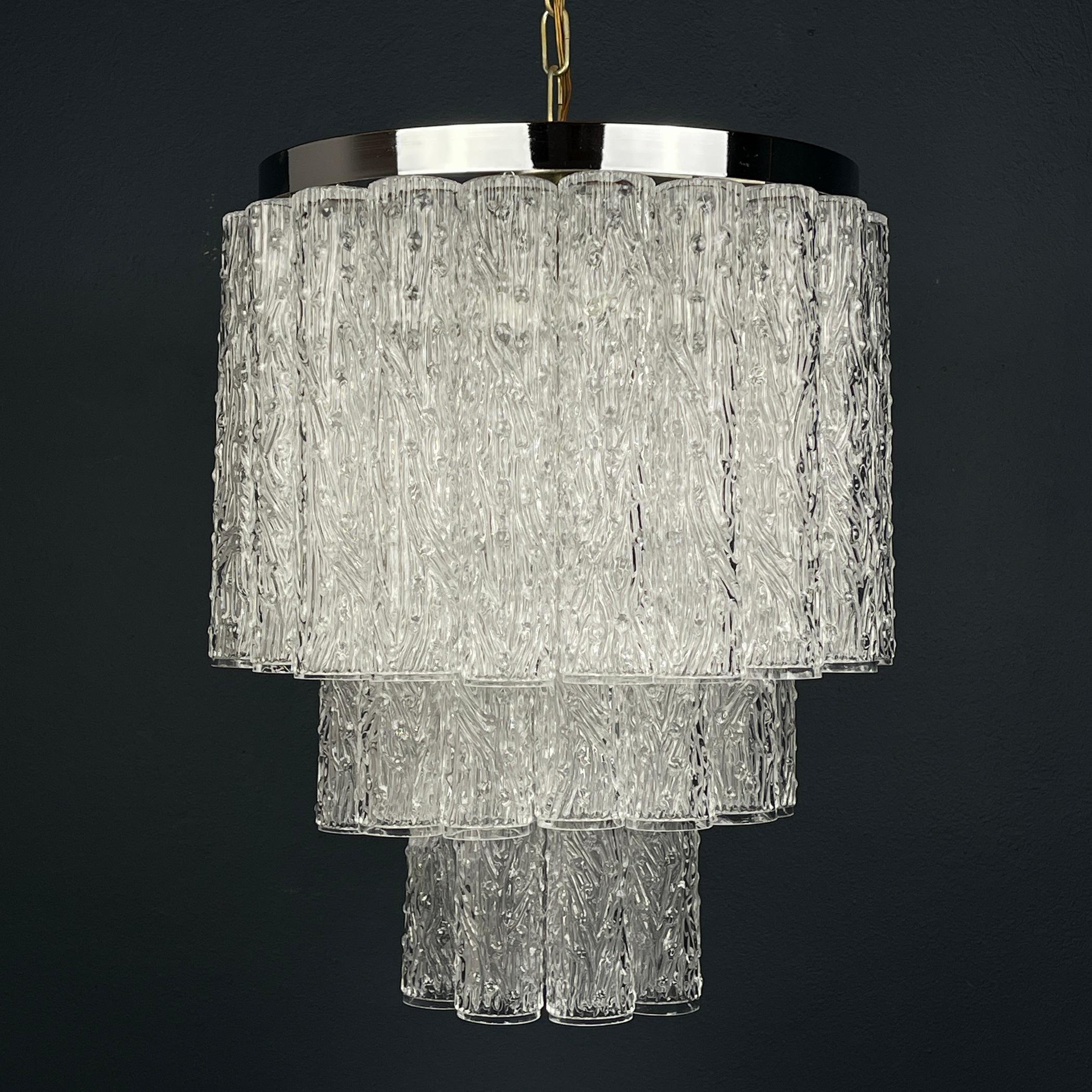 Illuminate your space with the timeless elegance of this Murano glass chandelier, a masterpiece crafted in Italy during the 1960s by the renowned designer Toni Zuccheri for Venini & Co. Venini & Co. played a pivotal role in the revitalization of