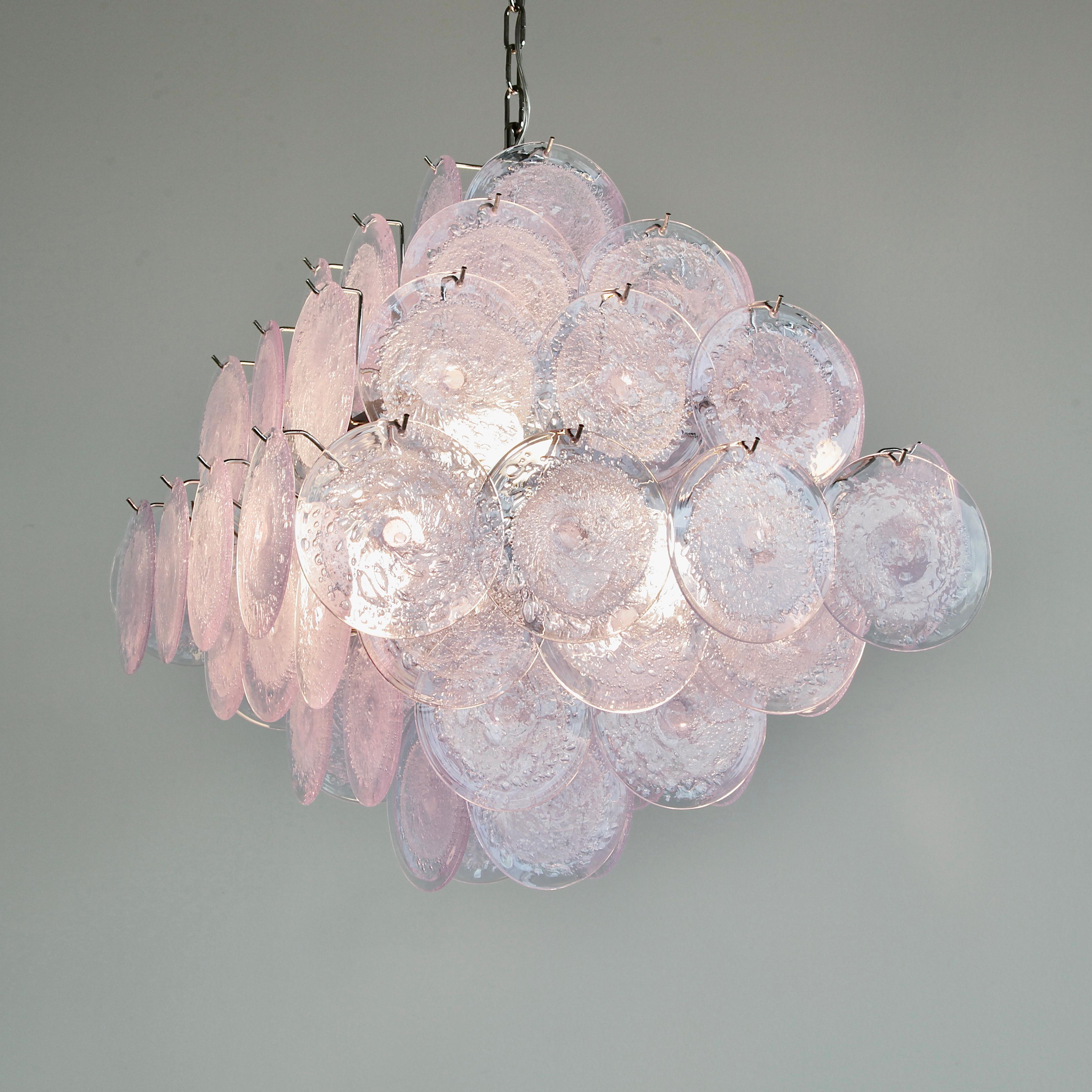 Large glass disk chandelier. Italy, Murano.

Chandelier with Lavender coloured glass disks, hand-made in Murano. Metal frame with eight light sockets.