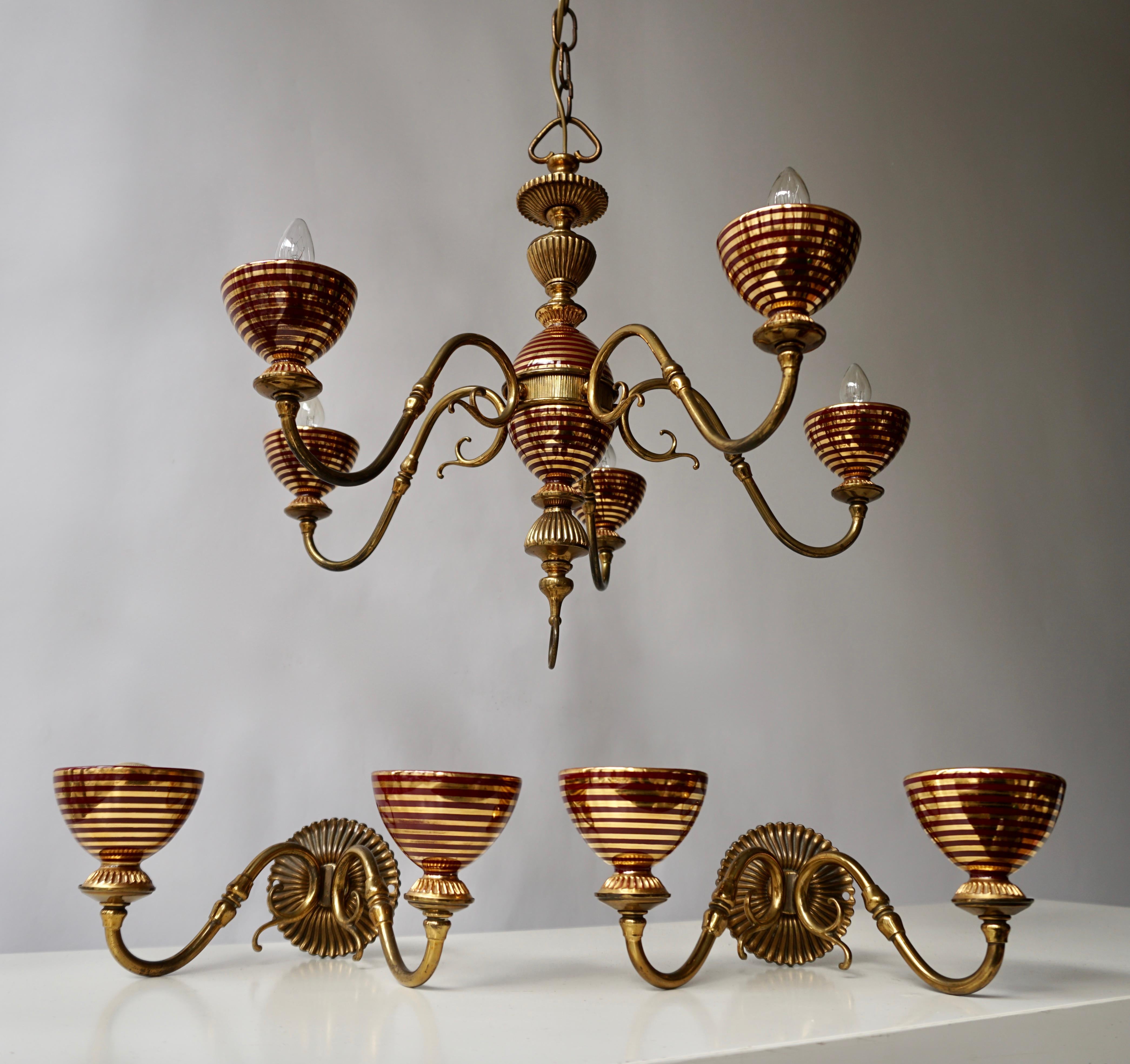 Italian Murano glass and brass chandelier with two wall lights.
Diameter chandelier 50 cm. Height fixture 40 cm. Total height including the chain and canopy 70 cm.
The chandelier requires five single E14 screw fit lightbulbs (60Watt max.)
Wall