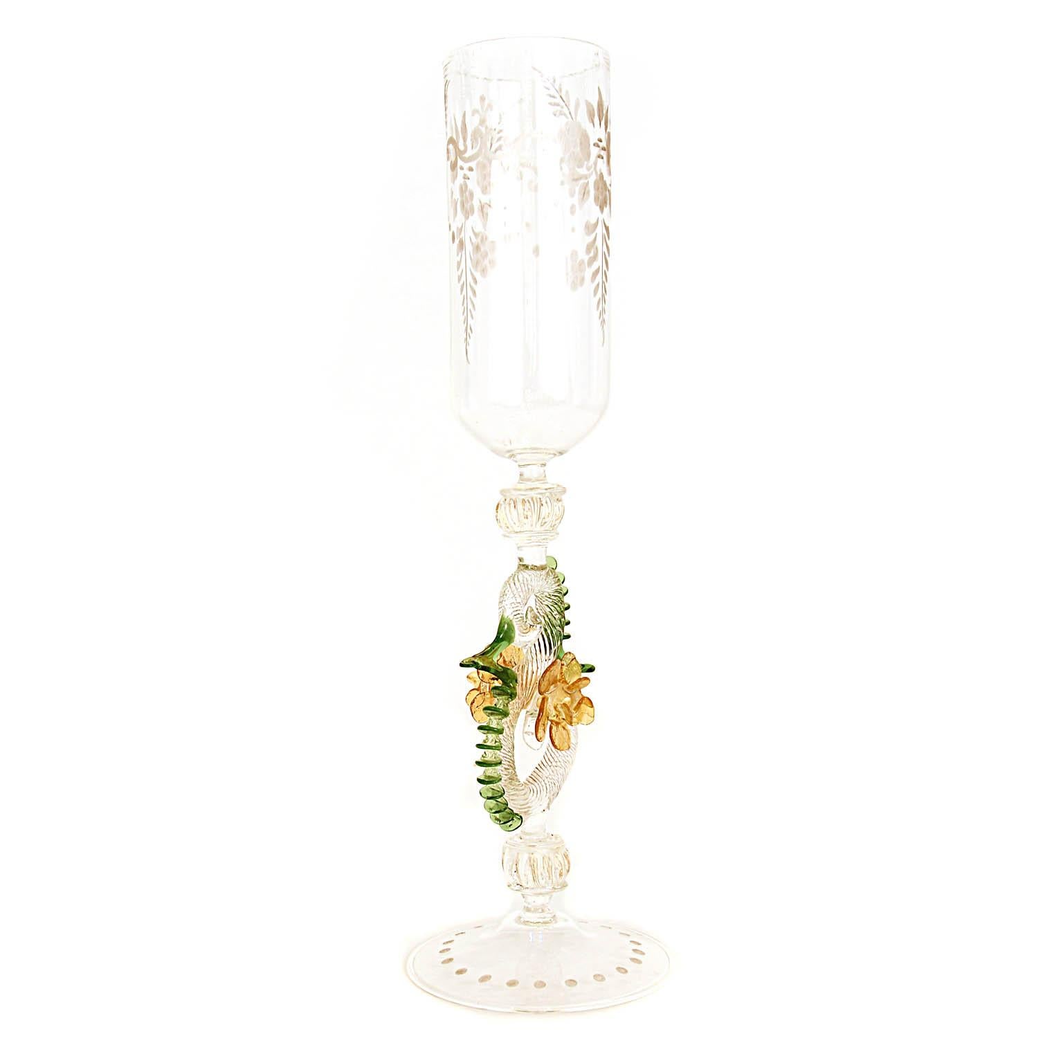 Italian handcrafted chalice in clear, amber and green glass.
The base is decorated with cutted dots, the chalice with cutted flowers The stem is adorned with different Morise decorations, has green blossoms on each side.
The glass has tiny