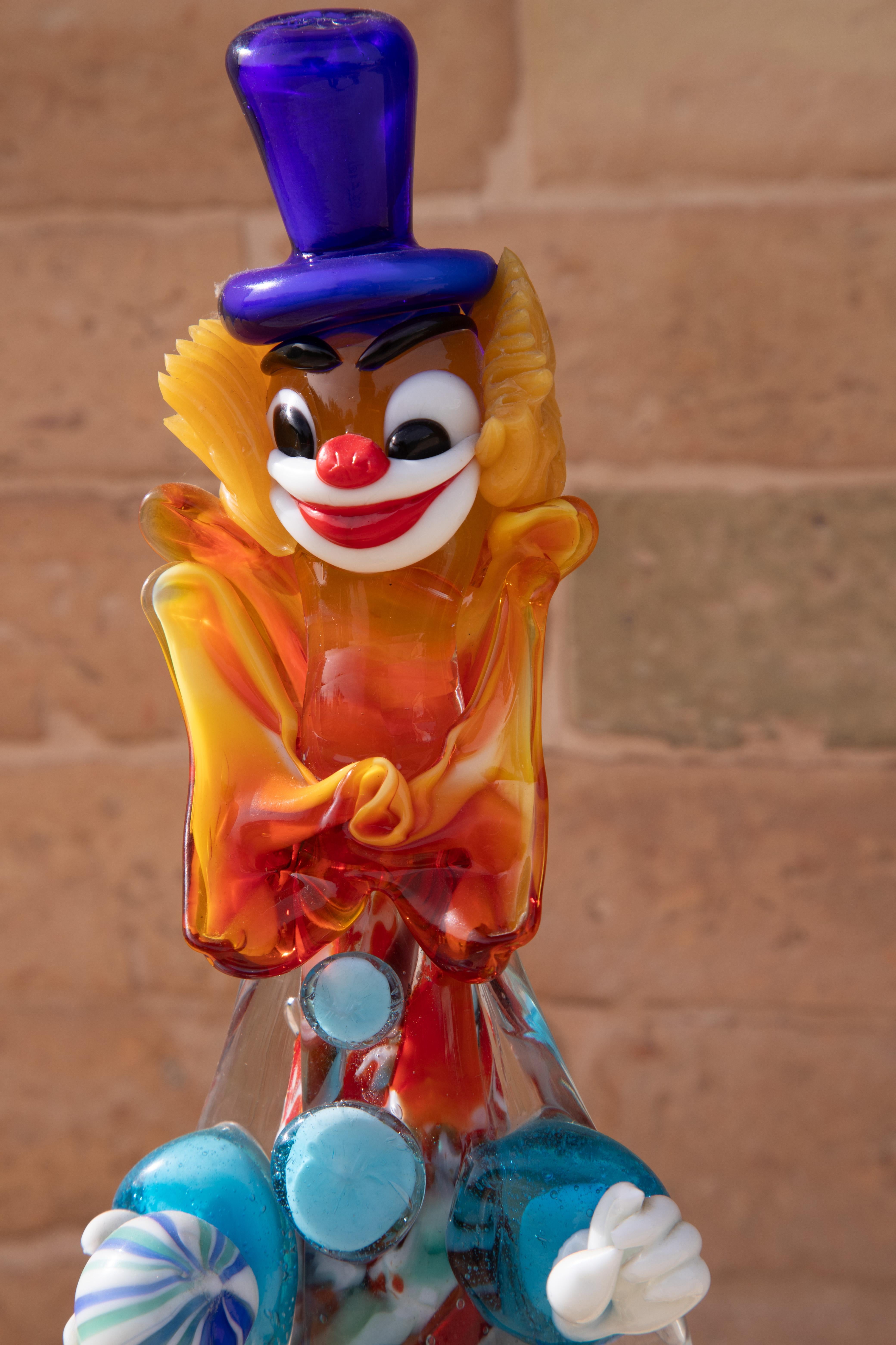 The glass clown was designed and manufactured in the Mid-Century Modern era in Murano, Italy.
 It is in excellent condition with no chips, cracks, or chiggers.