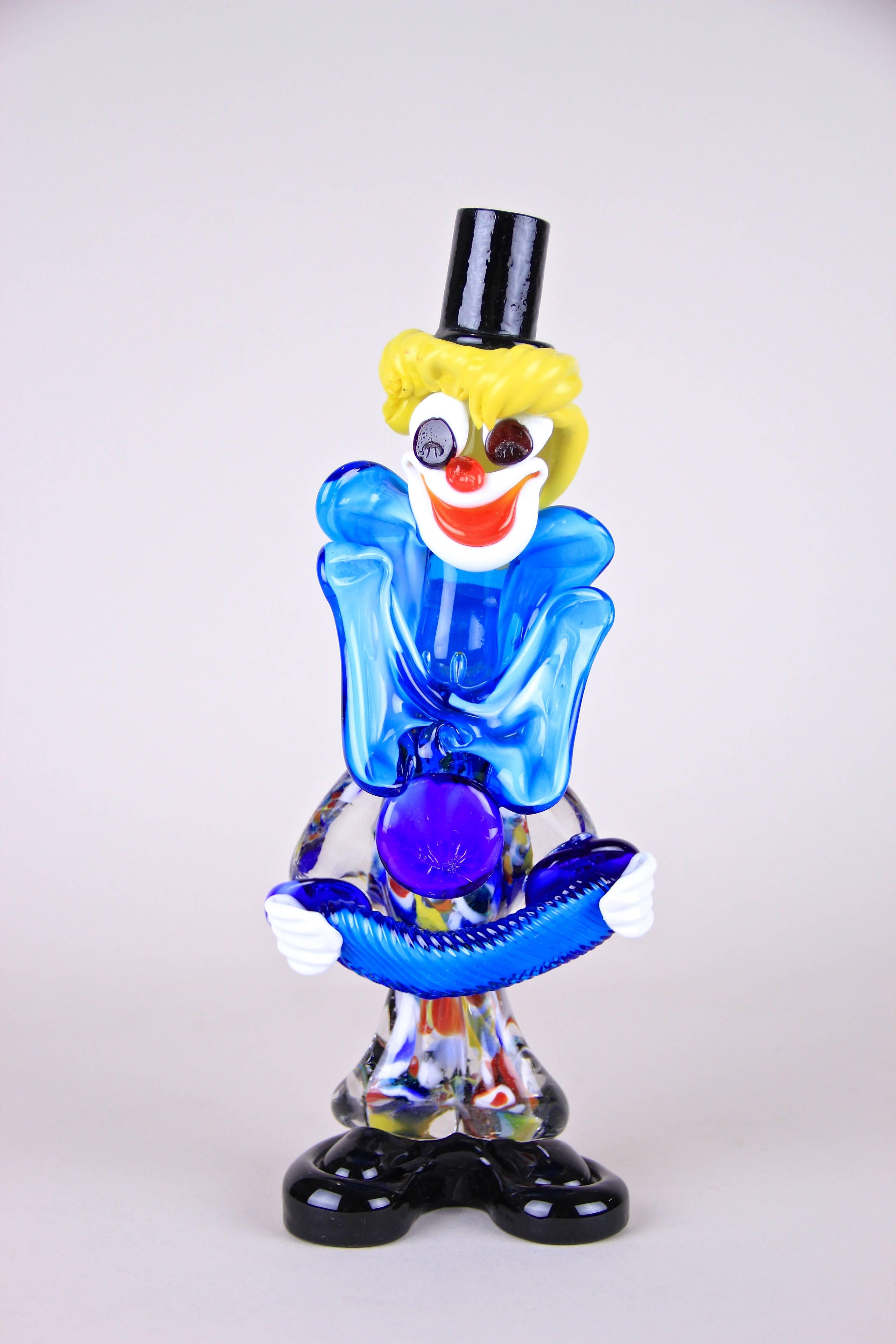 Amazing worked Murano glass clown from the famous Murano Glass factory out of Italy around the midcentury. A multicolored glass body, the great face with the yellow hair, the blue garment and a lot of other details like the accordion makes this