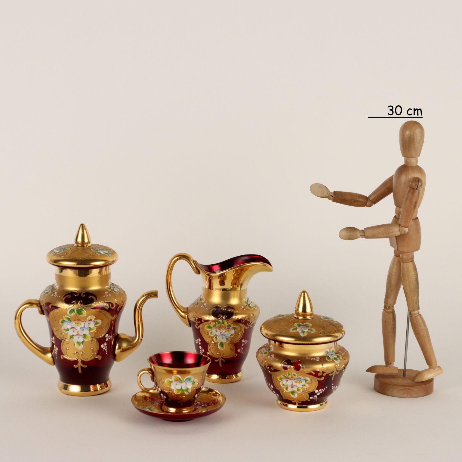 Coffee service for four people in ruby red glass with rich decorations in gold and glass paste in relief.