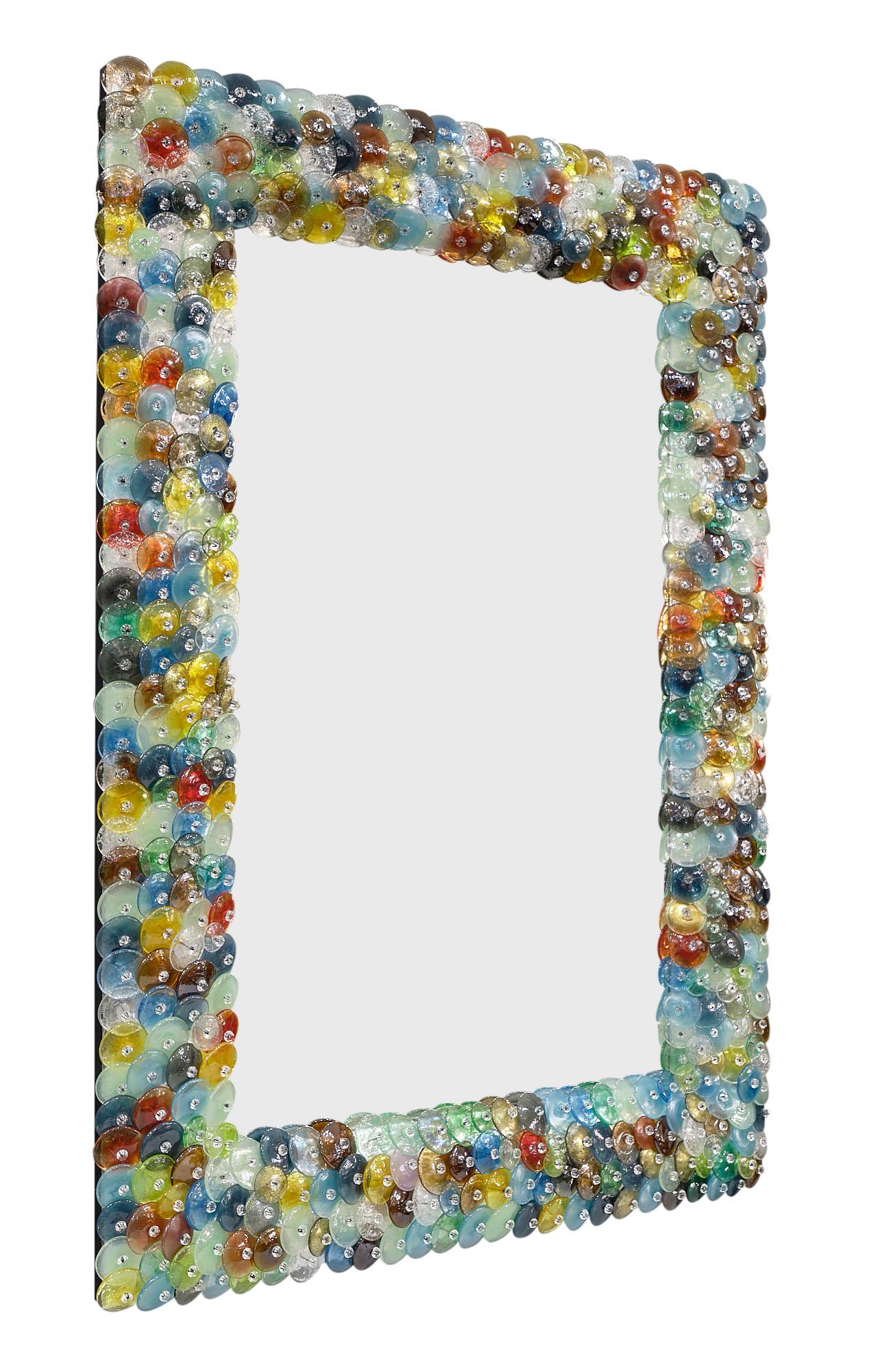 Murano glass “coriandoli” mirror made of hand-blown glass pieces or “pastille” in a variety of colors. The name “coriandoli” means confetti. We love the beautiful detail of this piece.