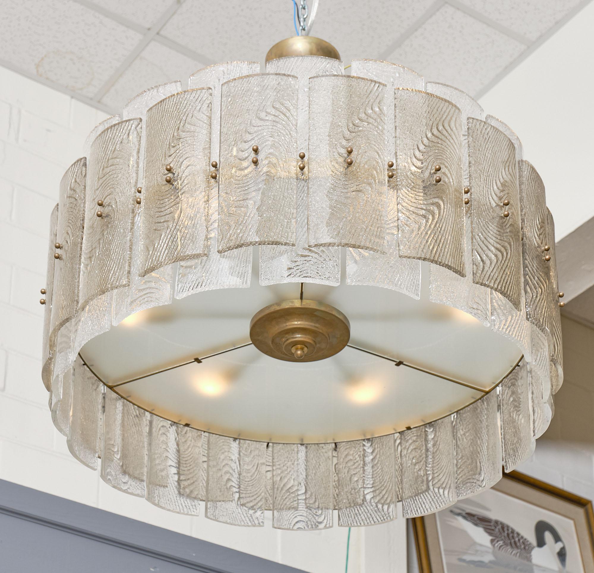 Chandelier, Italian, from Murano with hand-blown Corteccia glass in a drum shape. This fixture features multiple “piastre” attached to a brass structure. The glass slabs are textured and lightly tinted. It has been rewired to US standards. The