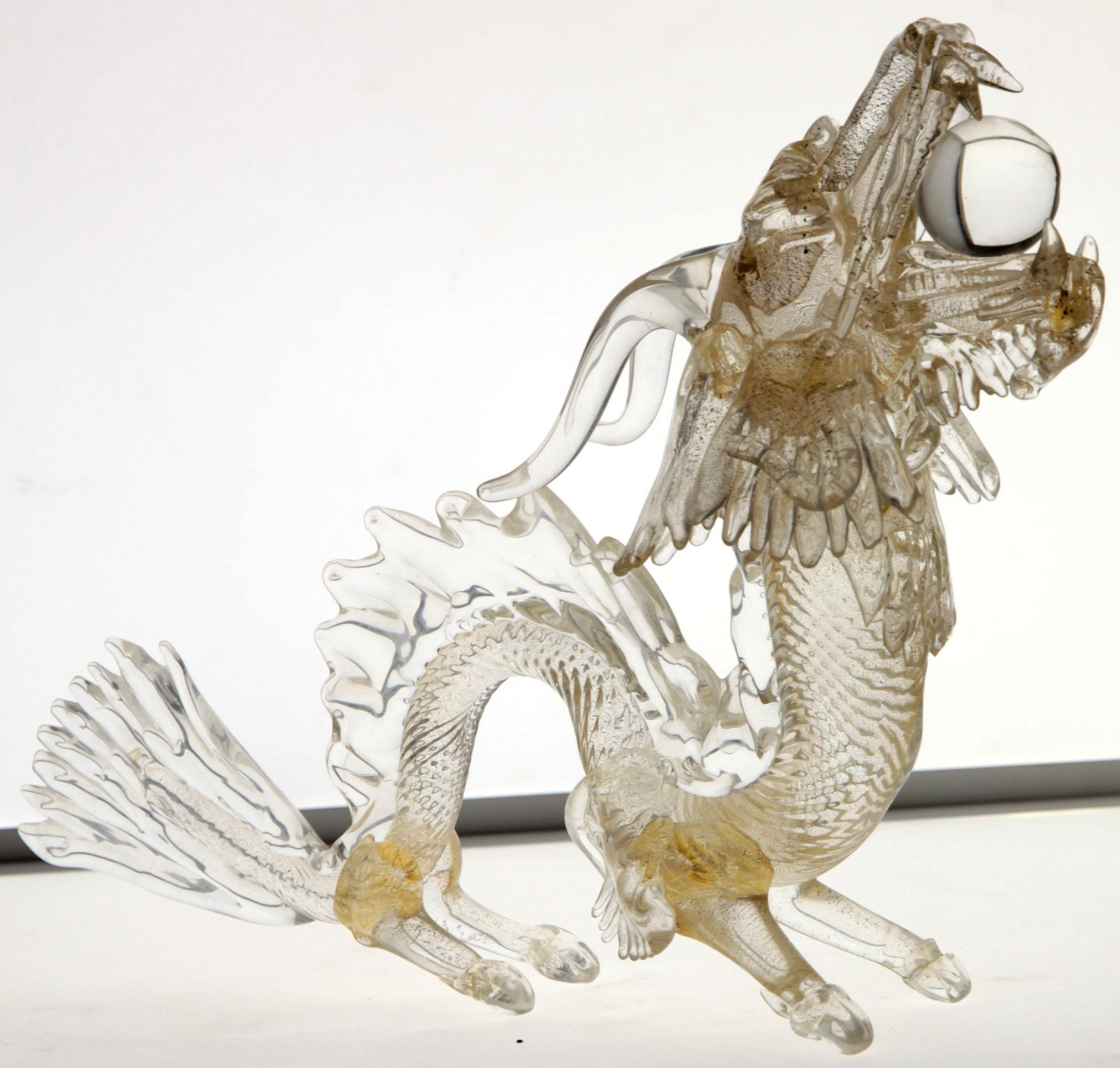 Glass dragon made with care of details and using clear glass with 24-carat gold leaf embedded int the glass.
Massiccio glass. 

Here it's represented in the typical position of the traditional Chinese dragon. 

Unknown autour, could be Licio