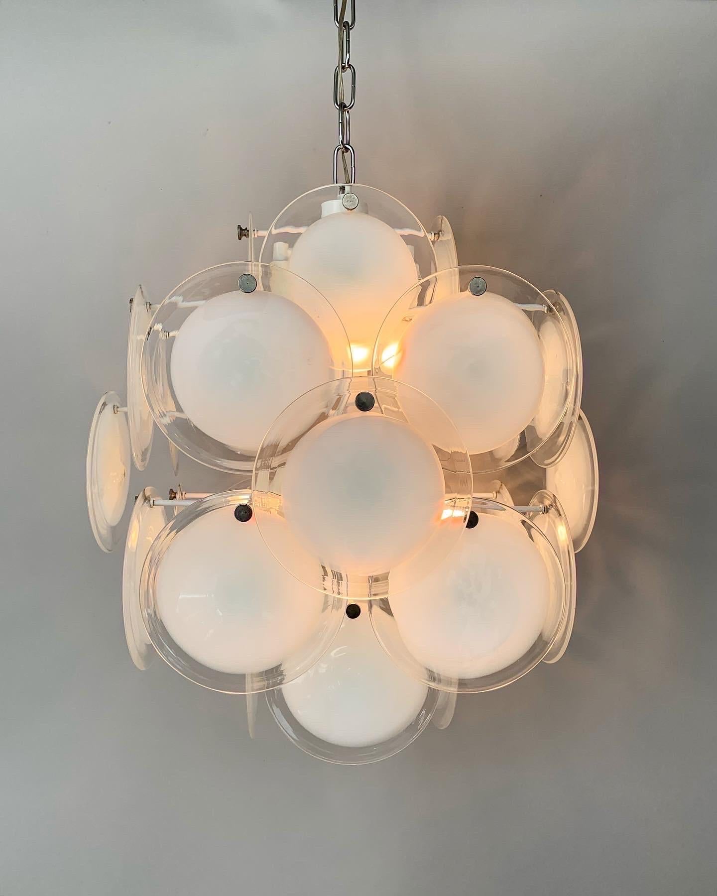 talian Murano glass disc chandelier, made in Italy in the 1970s.

These chandeliers are usually attributed to Vistosi, but were actually produced by many different manufacturers in Italy, mostly by Mazzega.

White lacquered construction with
