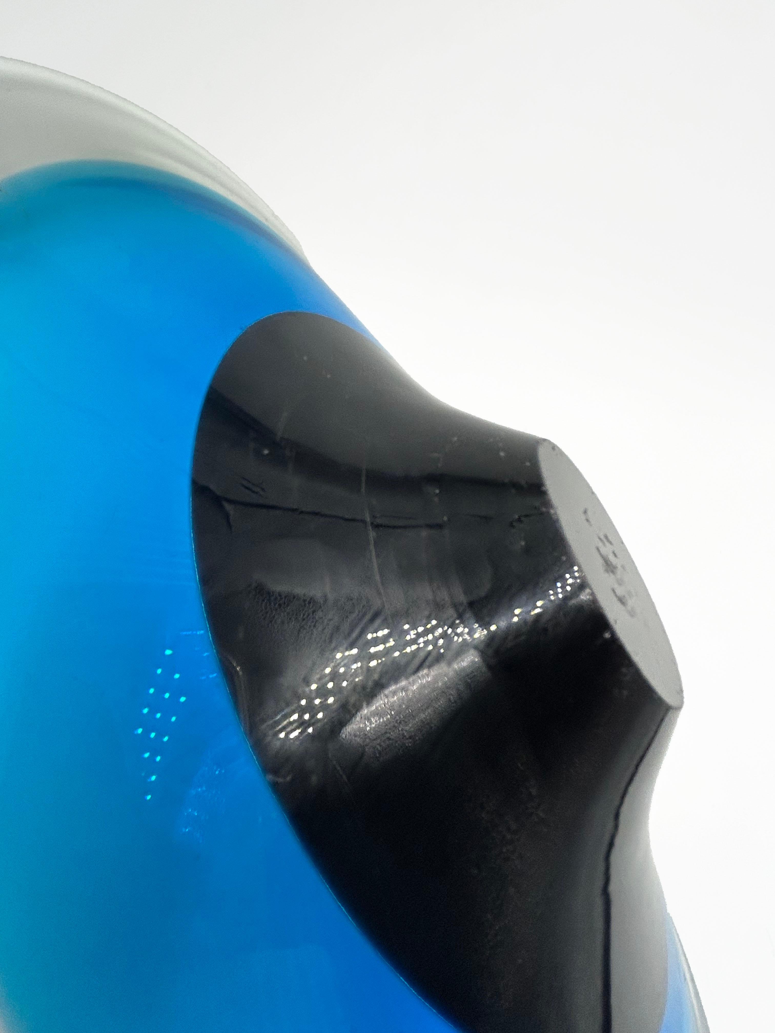 Murano Glass Sink in Blue Tones
This Murano glass sink, crafted using the sommerso technique in the 1960s, features a vibrant gradation of blues that blend into a deep black core. Its organic, gently undulating silhouette enhances the purity of the