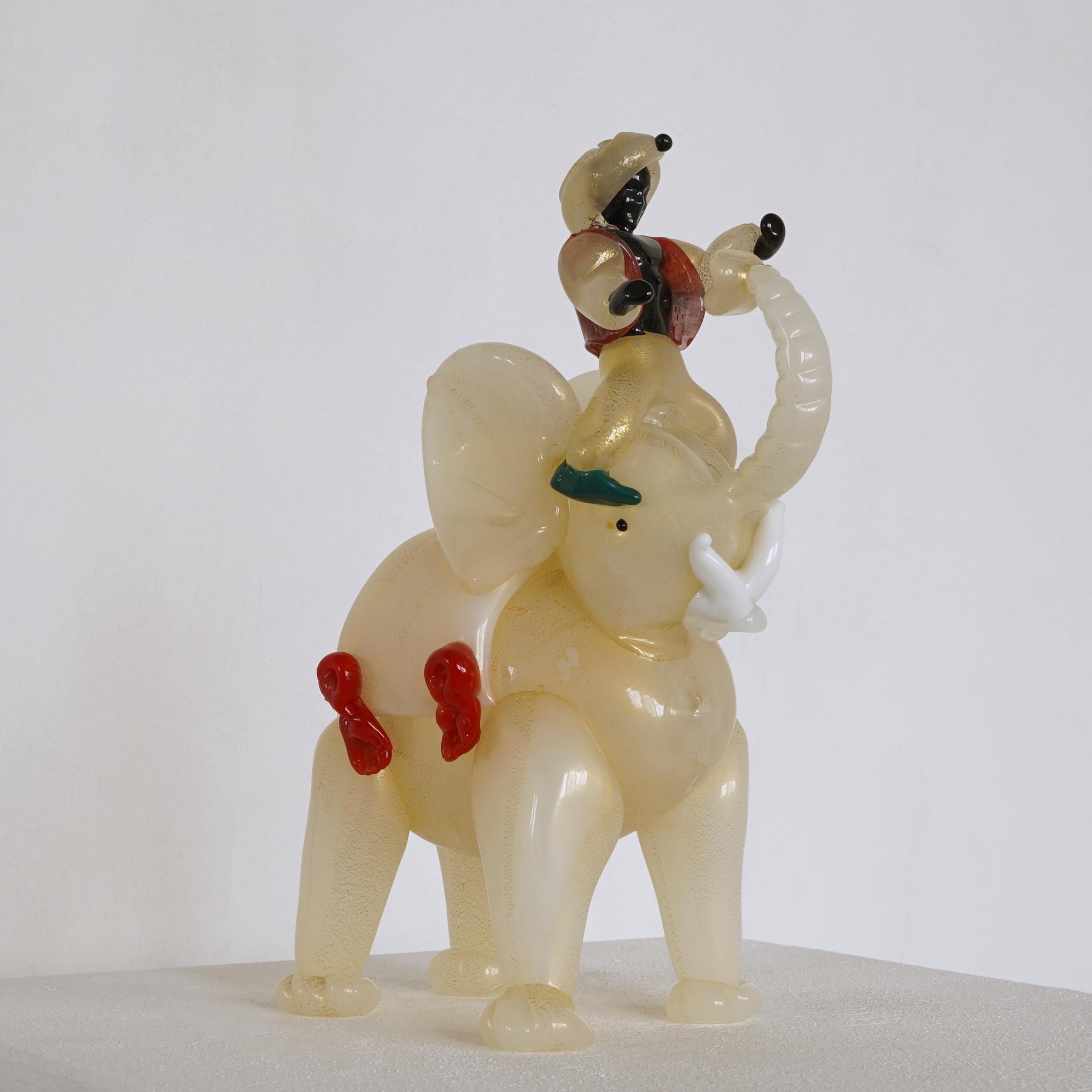 This is a highly detailed and decorated Murano elephant made in the first half of the 20th century.

The elephant is made of beautiful gold flaked milky ‘lattimo’ glass with colored details and white tusks.

This museum quality piece is highly