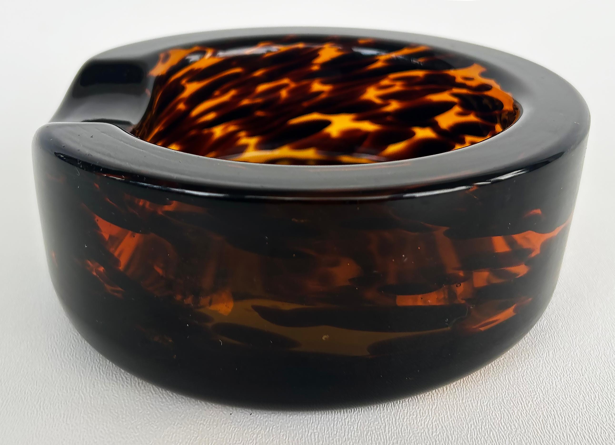 Murano Glass Faux Tortoise Shell Round Ashtray, Mid-Century to-late 20th Century

Offered for sale is a striking and substantial mid-century modern round Murano-Glass ashtray with a faux tortoise shell design.  This piece is unsigned but was