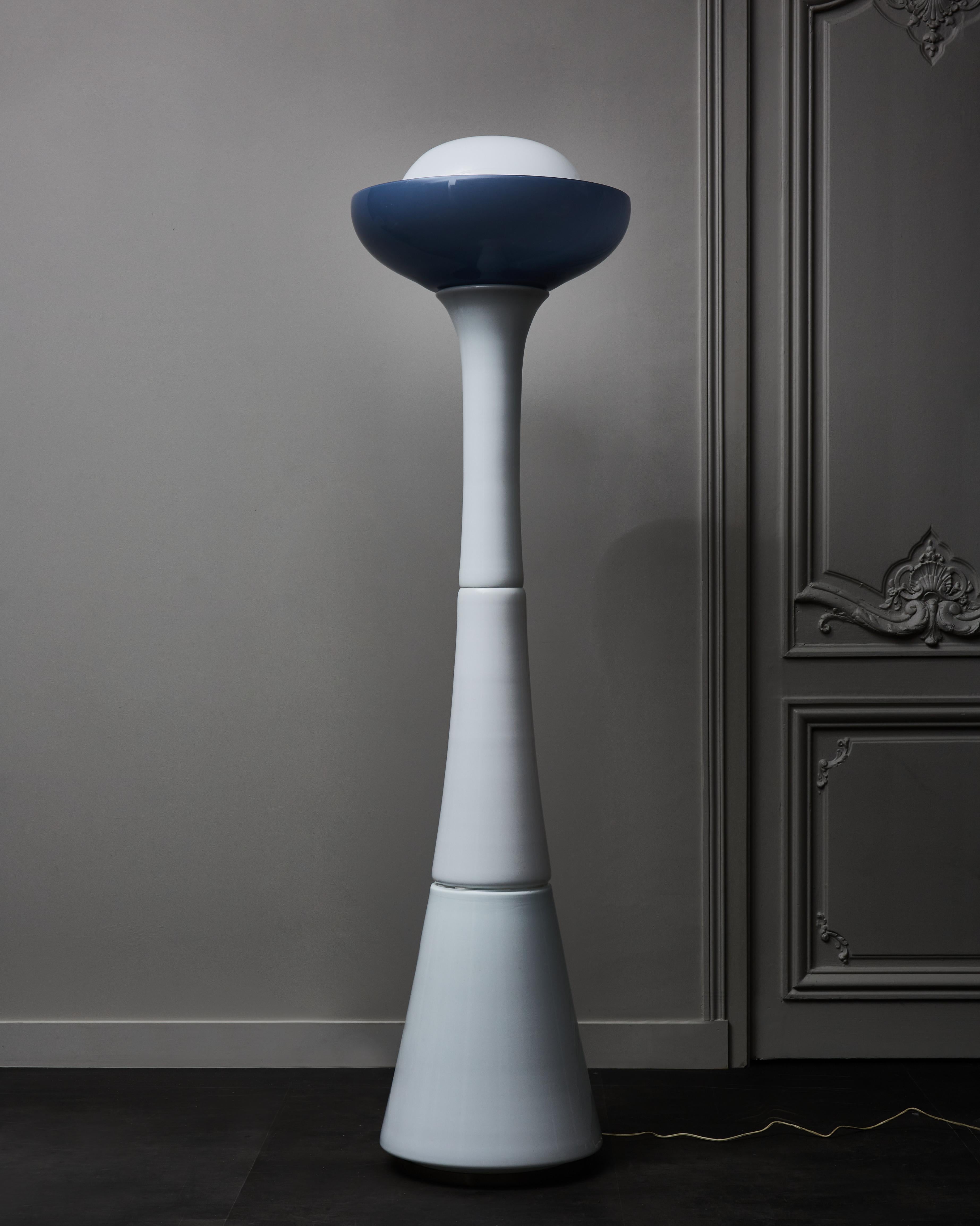 Beautiful floor lamp made of stacked opaline Murano glass.
The curved shape of the body ends up with a blue cup giving a loverly hue when the piece is enlightened.
 