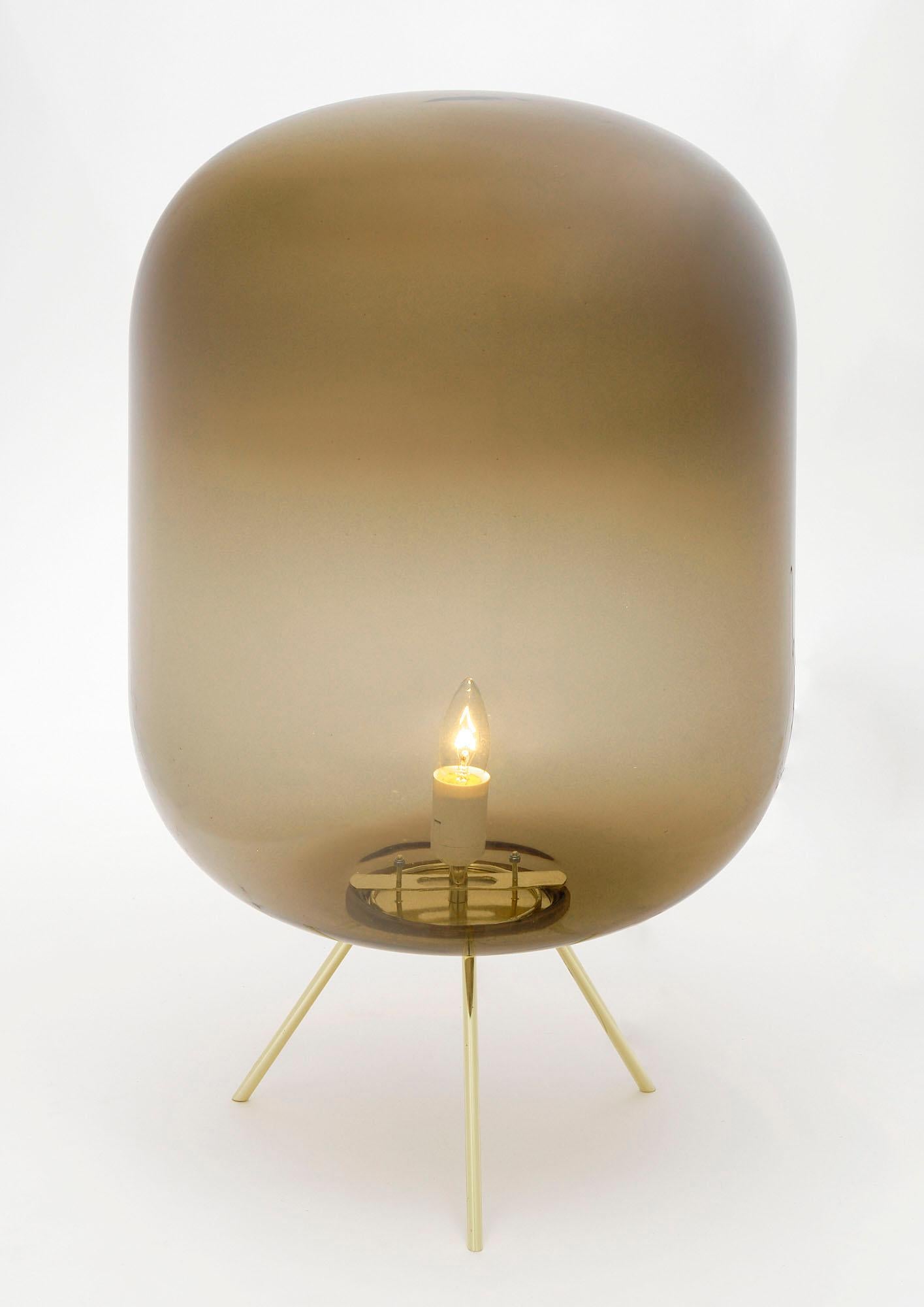 Lamp made of Murano glass in a smoked color with a tripod gilt brass base. This piece has been newly wired to fit US standards.