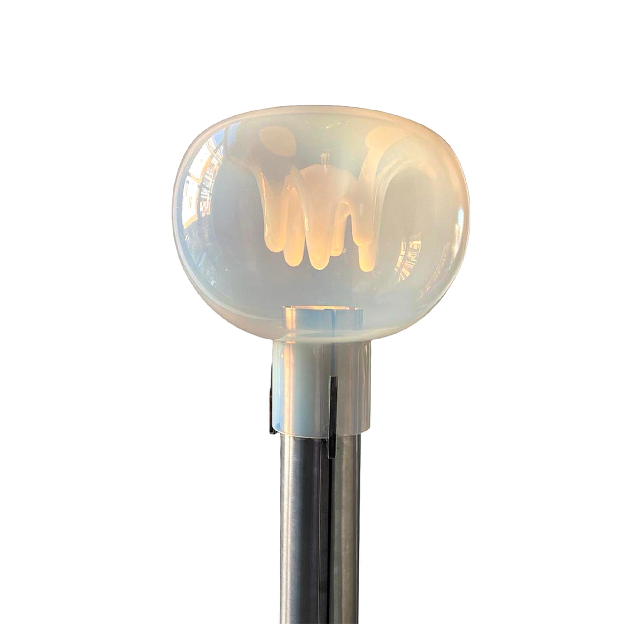 This floor lamp is an absolute eye catcher.

The large Lattimo, frosted glass ball, 40 cm high and 32 cm wide, sits on a very simple matte aluminium brushed base.

The white hand-blown glass stalactites hang inside the glass ball.

 The mouth