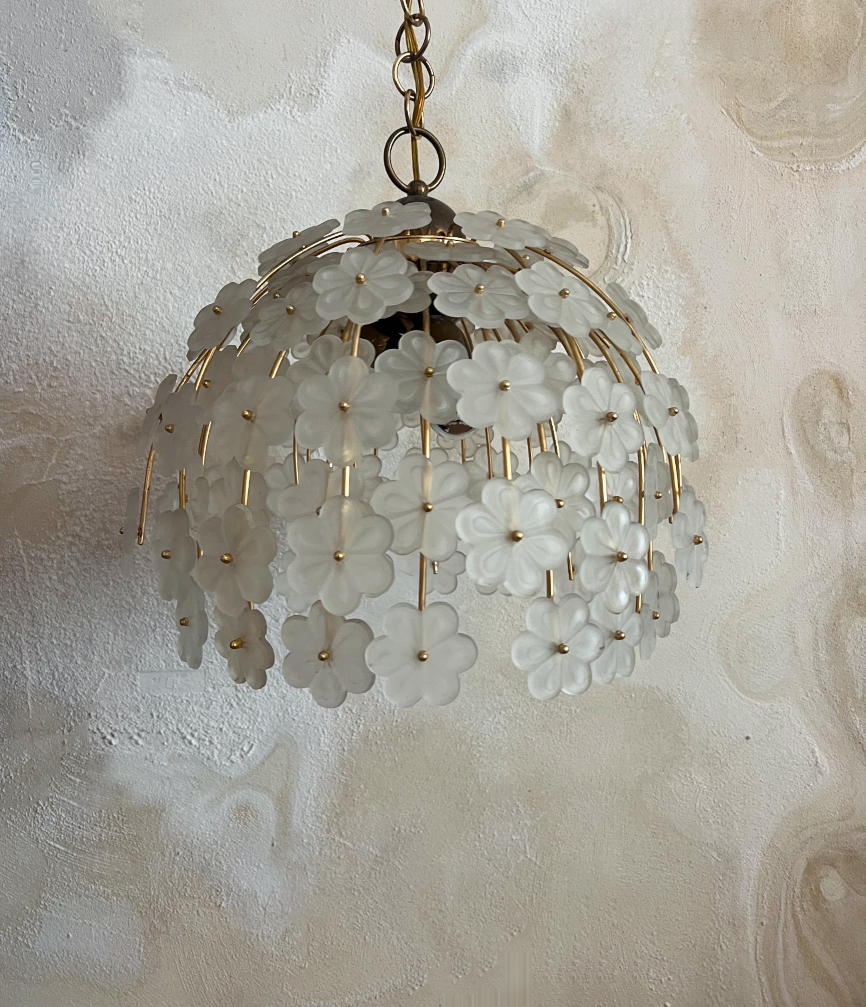 Absolutely Stunning MidCentury Modern Murano Glass Floral Chandelier

This exquisite Murano glass chandelier is a truly stunning. The chandelier features a captivating arrangement of Murano glass flowers each meticulously crafted and mounted on a