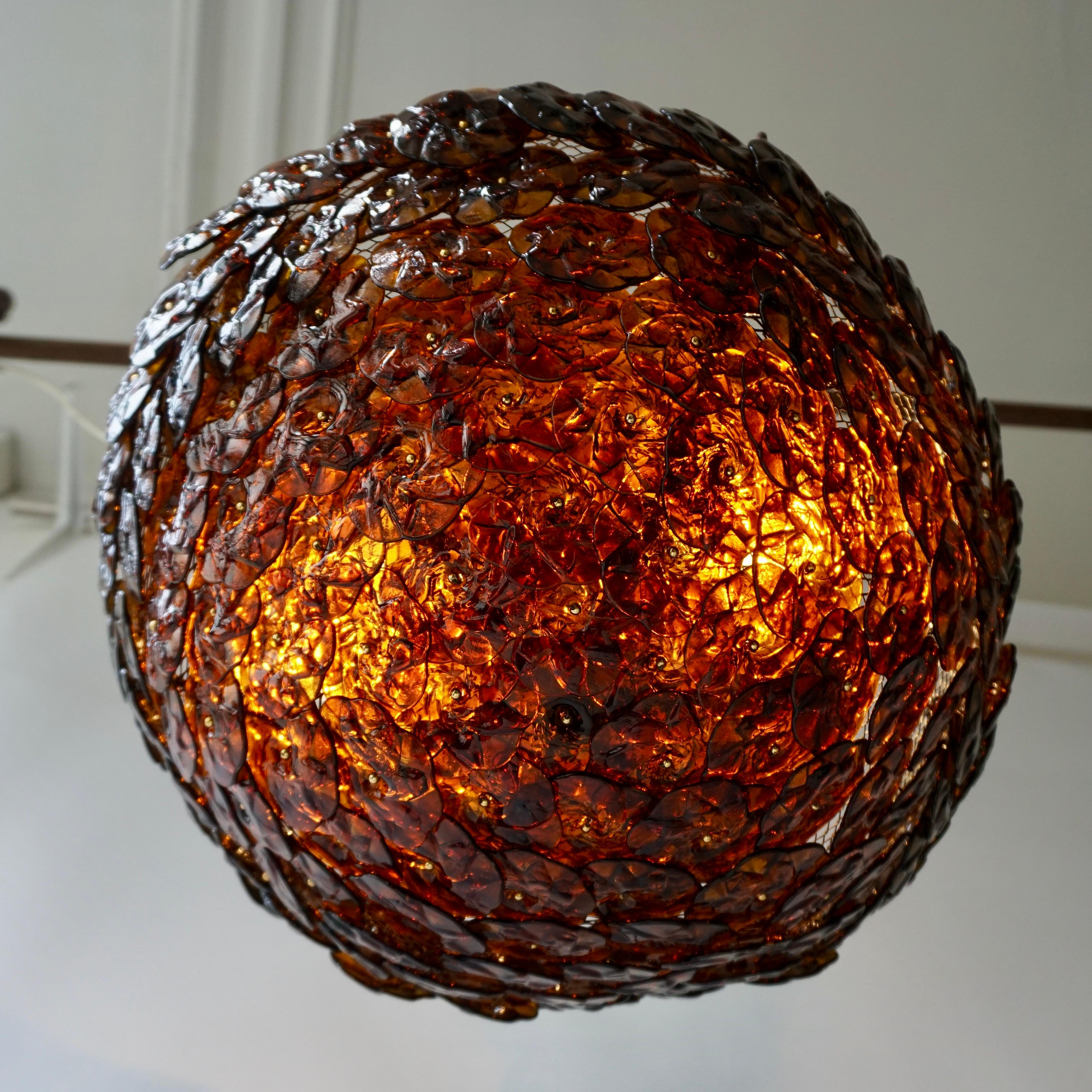 Decorative and rare Mid-Century Modern Italian flush mount ceiling fixture or wall lamp from circa 1960s. Manufactured by Barovier & Toso, Italy. 
The lamp consists of numerous amber Murano glass flowers. 
The lamp is executed with two E27 bulb