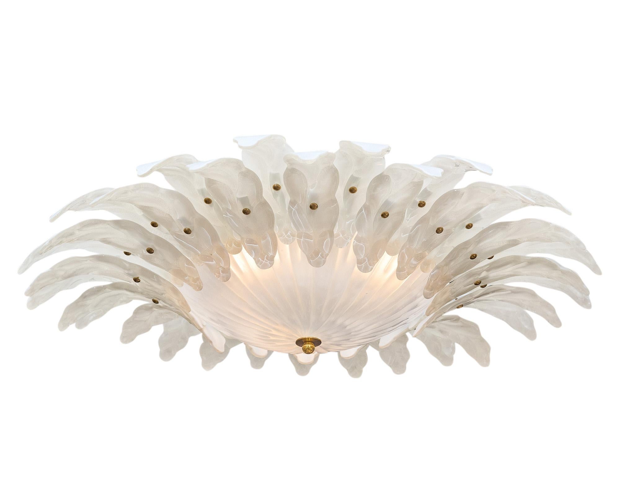 Flush mount fixture made of hand-blown glass elements. Each glass petal circles a central hand-blown glass cup. We love the frosted glass and the stamped details on each. This has been newly wired to fit US standards.

The current height from