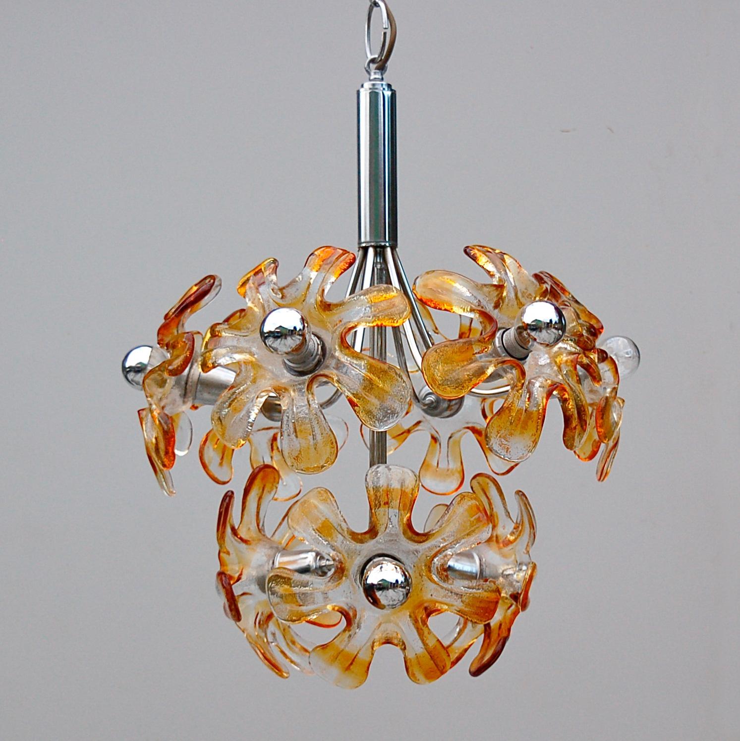 Murano glass and chrome chandelier, pendant lamp, produced by Italian manufacturer Mazzega in the 1970s. It has eight clear and amber mouth blown glass shades in the shape of blooming flowers mounted on a chrome frame. 