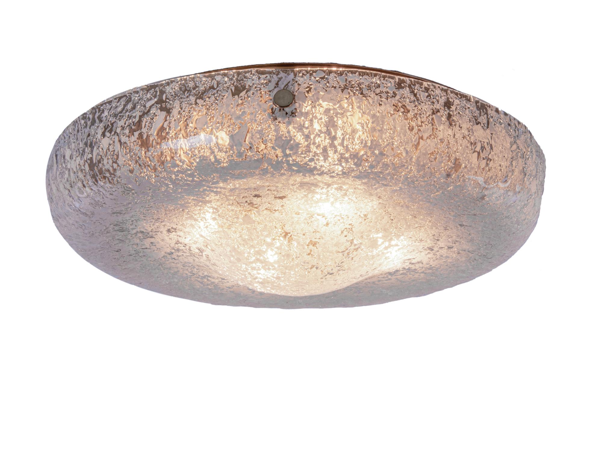 Elegant drum-shaped flush mount ceiling light made of heavy blown Murano glass on a golden frame with brass finals. Illuminated, the lamp appears amber in color with white spots. Manufactured by Kaiser Lighting, Germany in the 1960s. 

Colors: