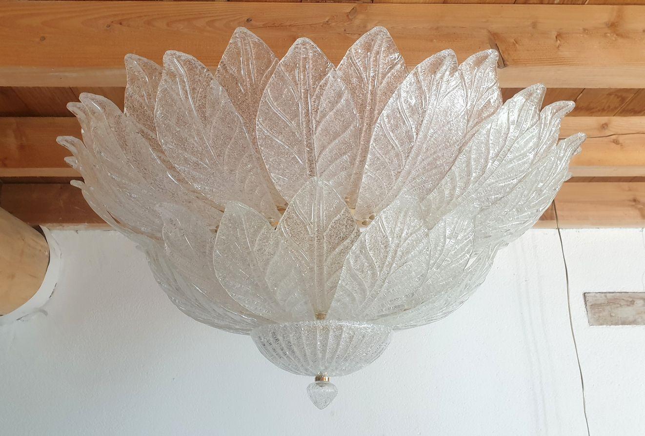 Large and elegant neoclassical style Murano glass flush-mount chandelier, by Barovier & Toso, Italy circa 1970s.
The Mid-Century Modern Murano chandelier is made of two layers of clear leaf glasses and a gold plated frame.
The Murano glass is