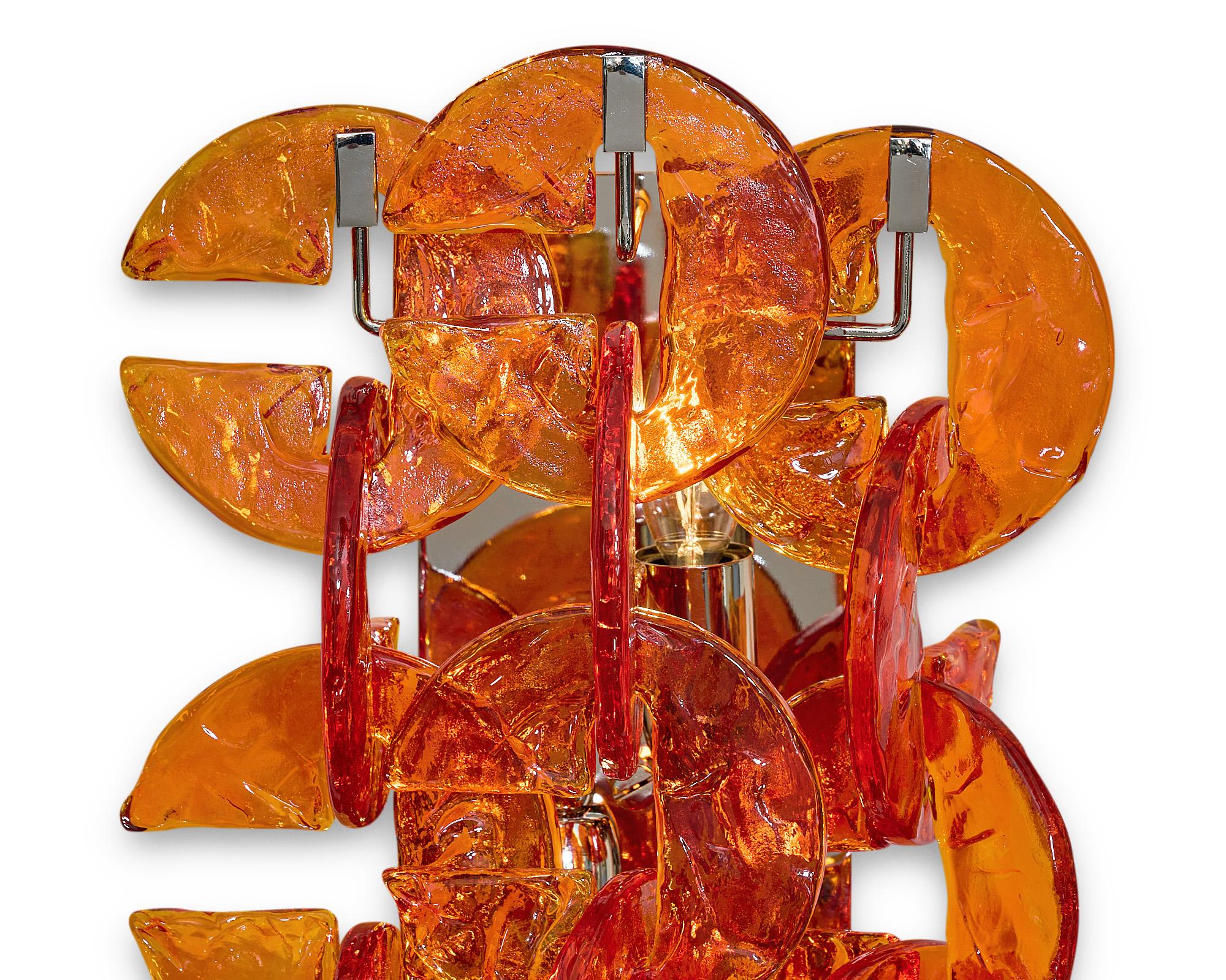 Pair of Murano glass sconces from the island of Murano, Italy. The sconces feature multiple C shaped orange hand-molded glass components in the “ferro Battuto” fashion. They sit on a chromed steel structure. This pair has been newly wired to fit US