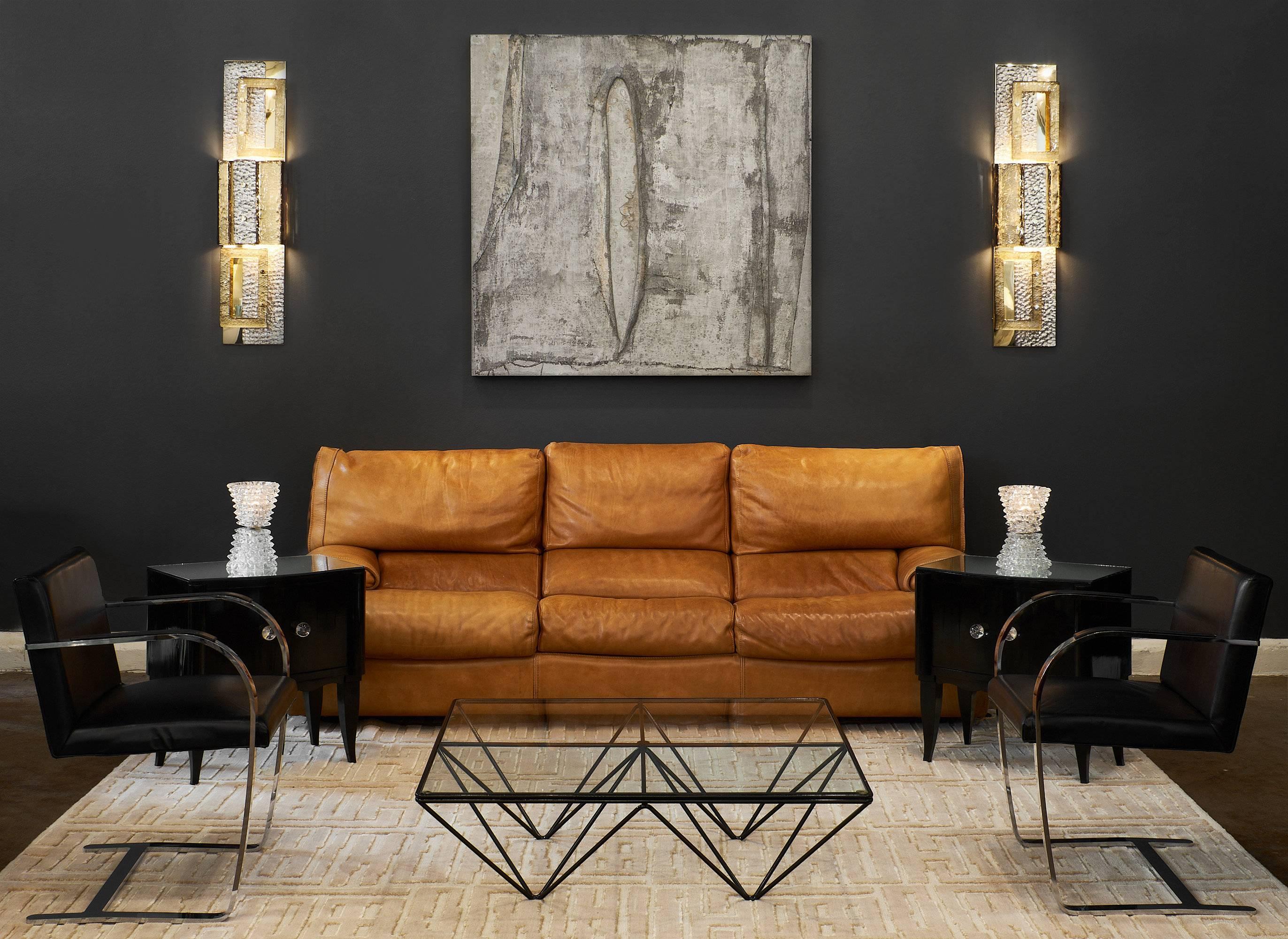 Important pair of geometric Murano glass gold sconces. These fixtures involve various techniques of stamped glass, golf leafing, and silver leafing. We loved the oversized sculptural impact of these sconces and the ultra modern combination of