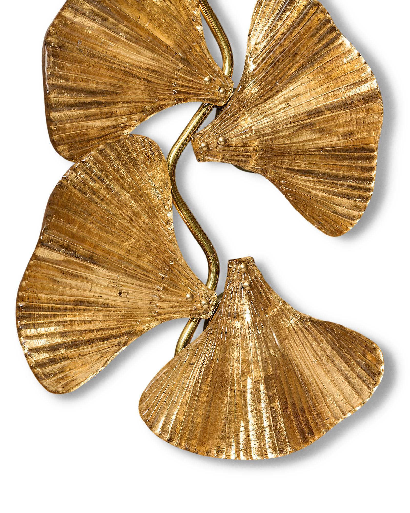 Pair of sconces, Italian, from the island of Murano. This pair is made of hand-blown glass with gold leaf in the delicate shape of gingko leaves. They are supported on a brass structure. Newly wired to US standards.