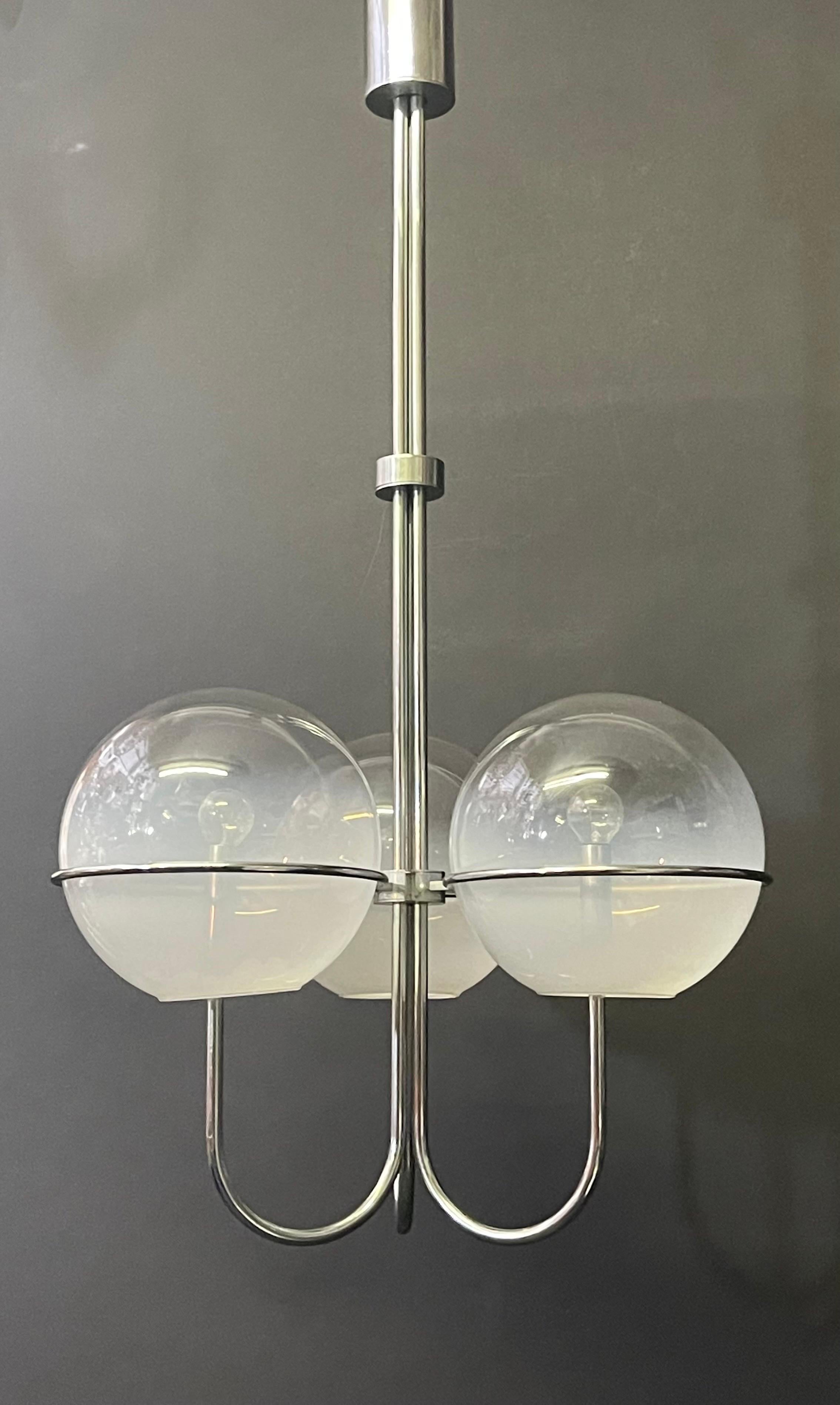 A fine mid - century modern opaline glass and chrome chandelier by Mazzega, Italy, circa 1960s.
Socket: 3 x E27 ( E26 for US) for standard screw bulbs.

 
 