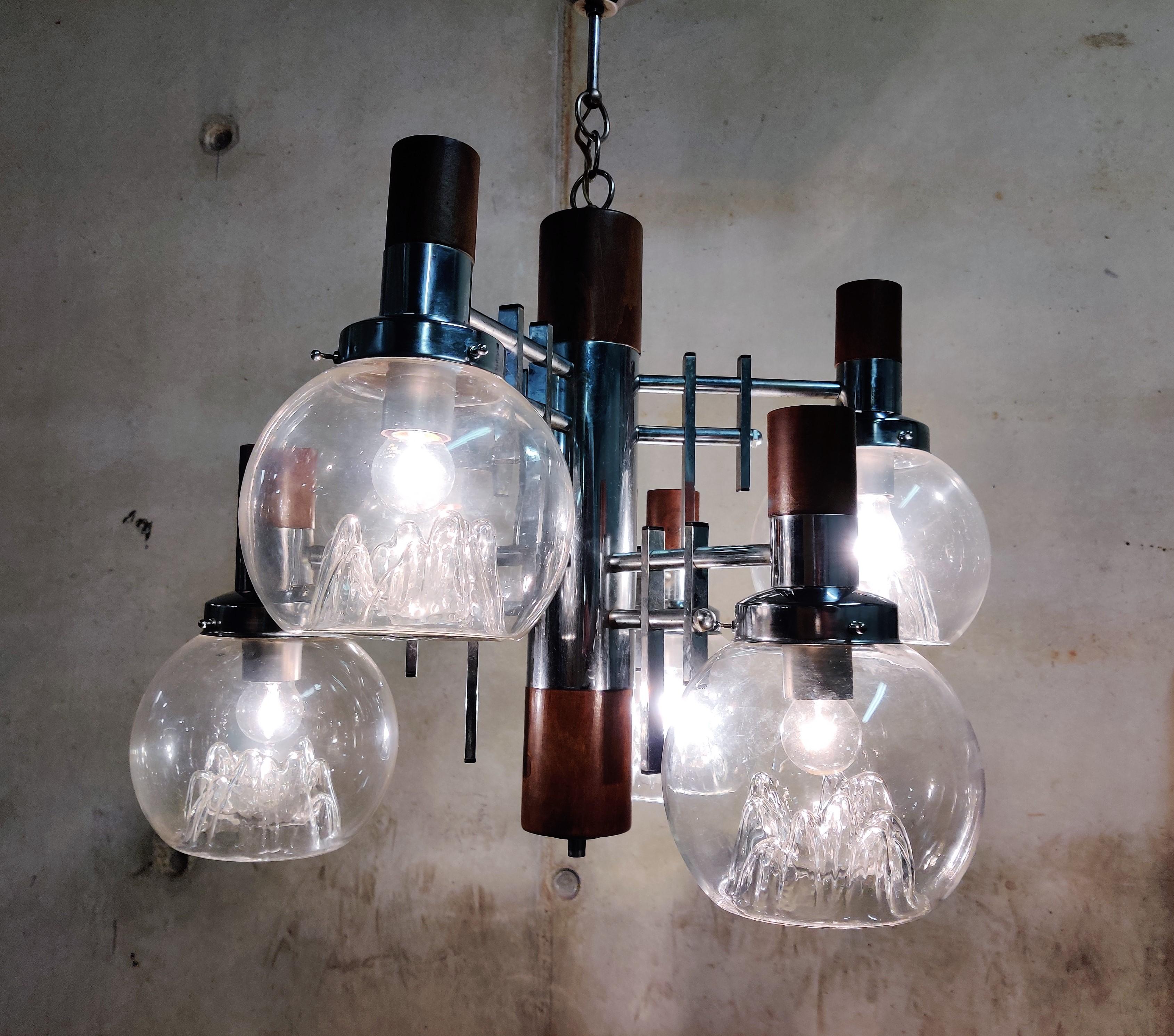 Midcentury chrome and blown glass chandelier by Mazzega.

The unique hand blown glass globes create a beautiful light effect.

Tested and ready to be used with eight E26/E27 light bulbs.

Light patina.

1970s - Italy

Dimensions:
Height