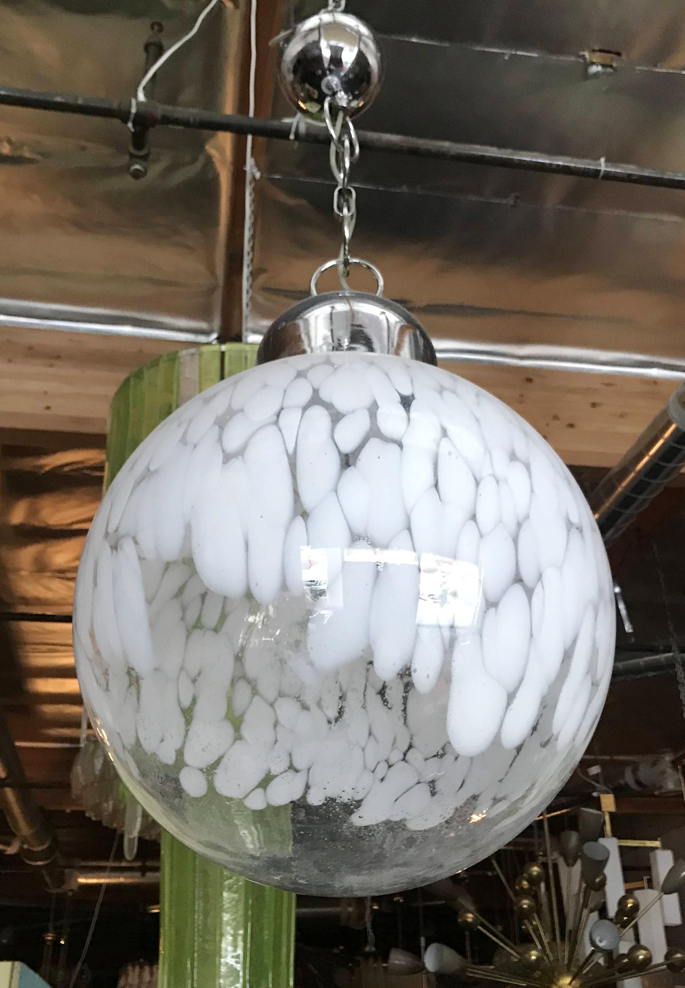 Italian Murano glass globe pendant blown with milky white pattern on chrome hardware, by Venini circa 1960s / Made in Italy 
Single light / E26 or E27 type / max 60W
Diameter 15 inches / Height 24 inches plus chain and canopy
1 in stock in Palm