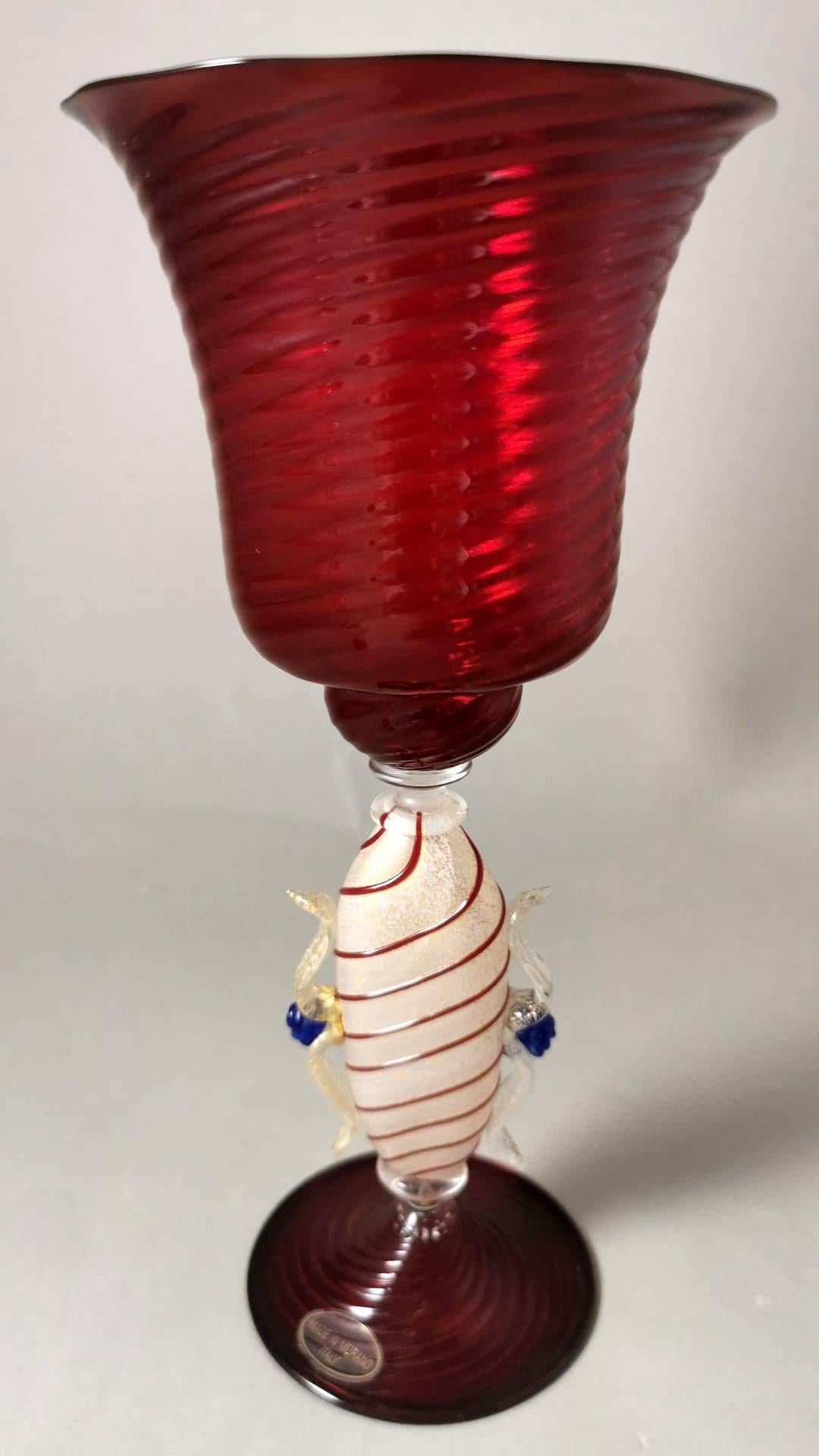 We kindly suggest that you read the entire description, as with it we try to give you detailed technical and historical information to guarantee the authenticity of our objects.
Exceptional hot-blown Murano glass goblet; it has a rare stem worked