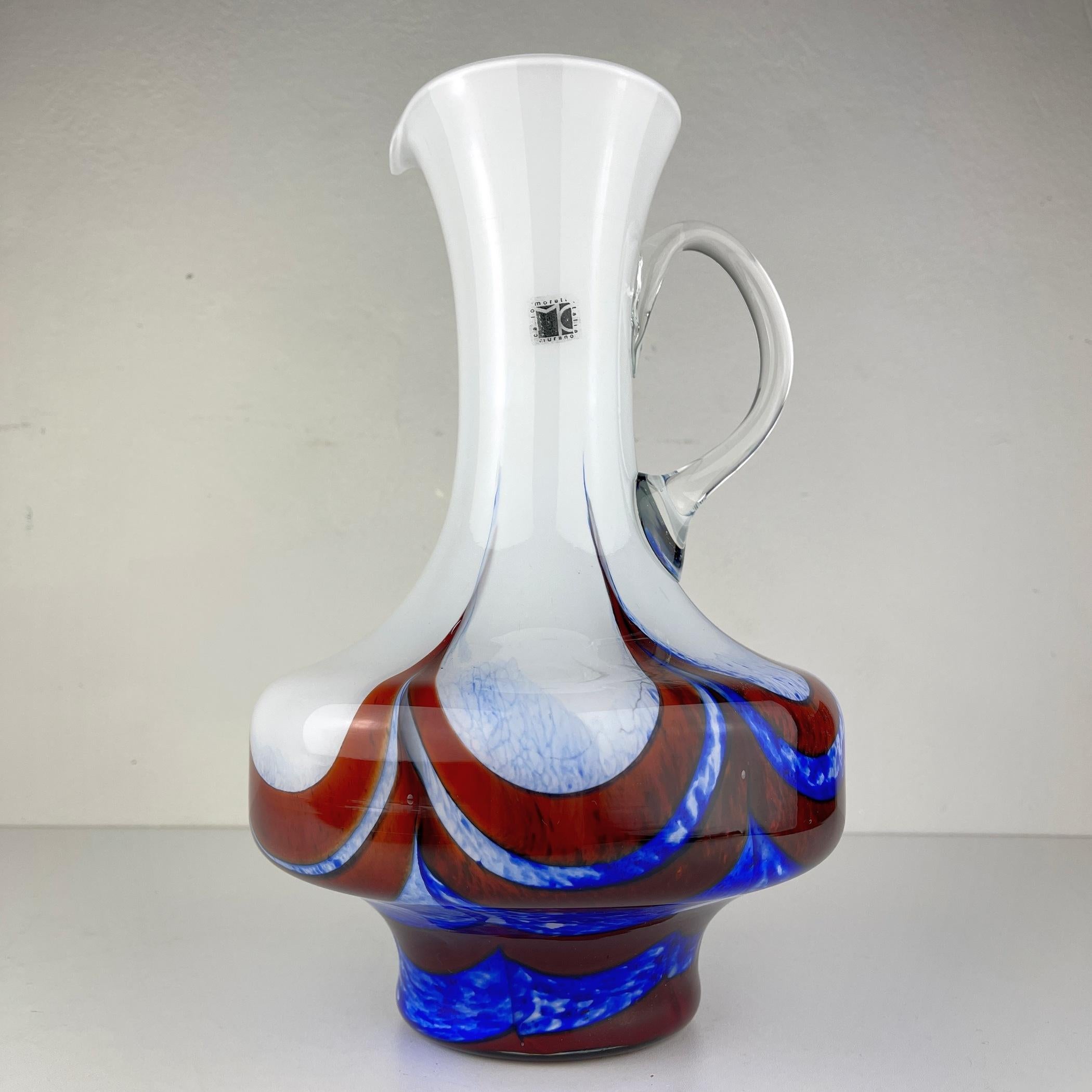 Beautiful murano glass pitcher by Carlo Moretti made in Italy in the 1970s. Carlo Moretti is a “factory of originals” founded in 1958 by Carlo and Giovanni Moretti, combining innovation and continuous research. Unusual original products are