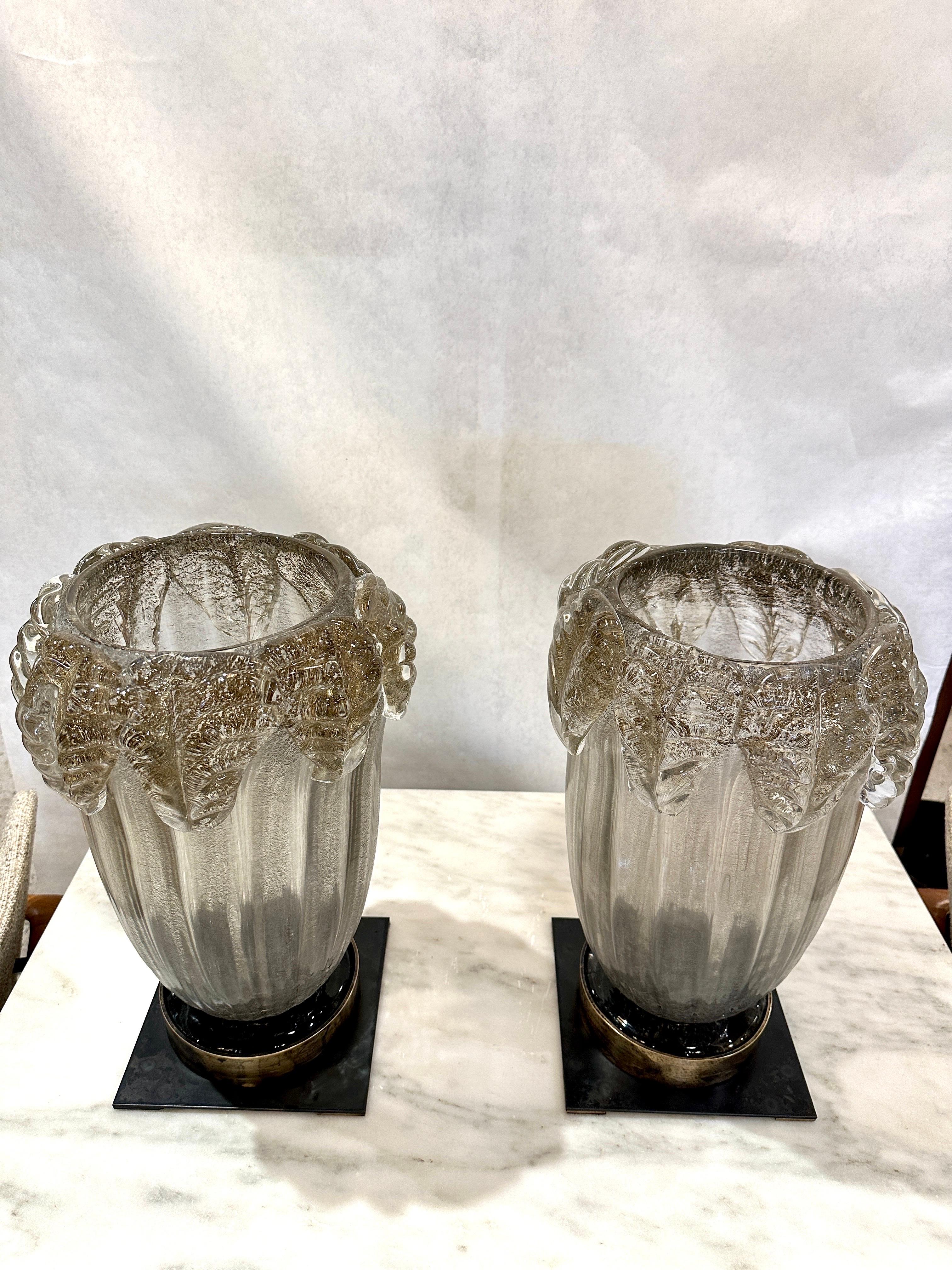These are VERY large Murano glass tall hurricane lanterns with bronze bases and brass candle holders to interiors.  These are a rich gray w/ subtle gold tones embedded in the glass, adorned at top rim with leaves. THIS ITEM IS LOCATED AND WILL SHIP