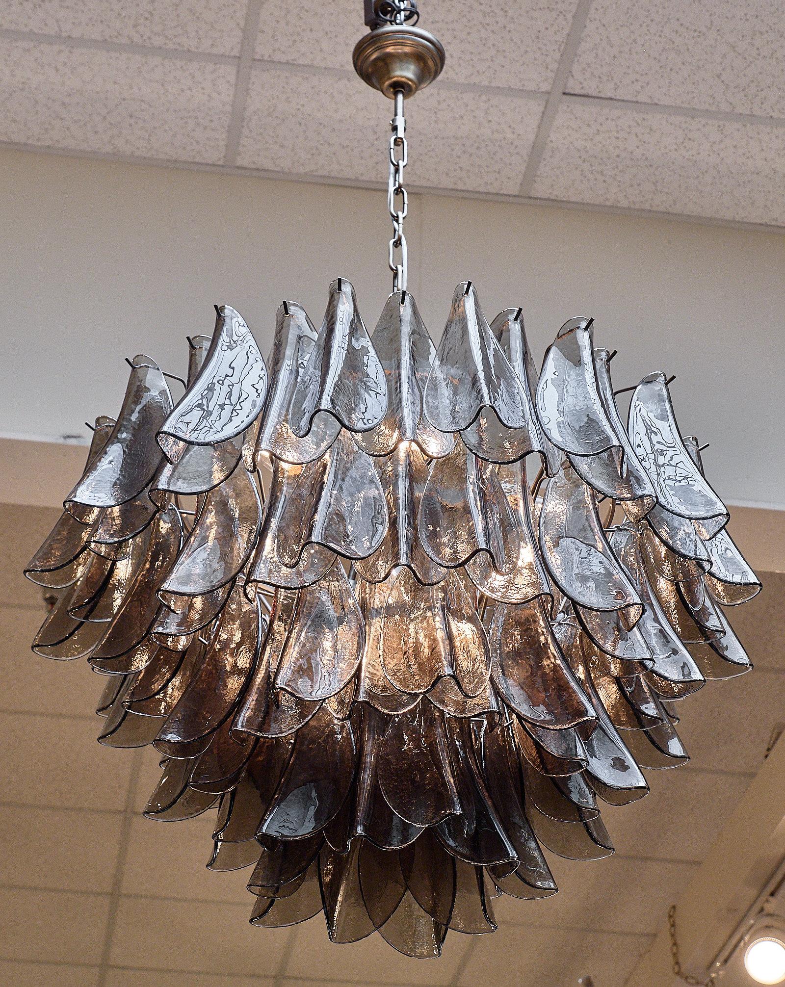 A stunning Italian Murano glass “foglie” chandelier with smoked glass leaf shaped components. We love the layered effect of the handblown glass and the light coming through the smoked glass. This fixture is newly wired to fit US standards.

This