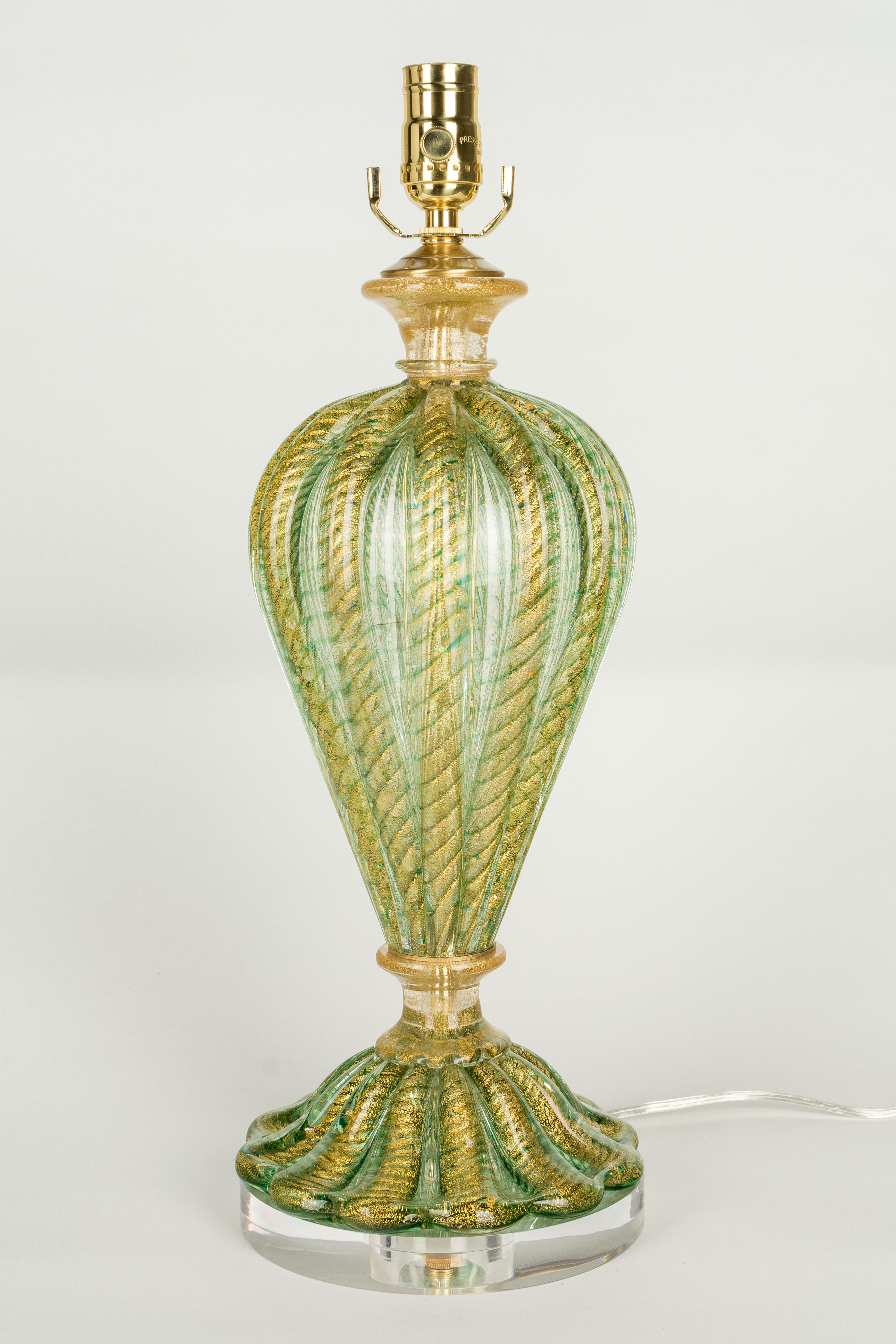 A midcentury Murano glass lamp by Barovier & Toso in a beautiful shade of apple green with bright gold inclusions. Glass is hand blown in two parts with real gold leaf inclusions using cordonato d'oro (ropes of gold) technique. Rewired with new