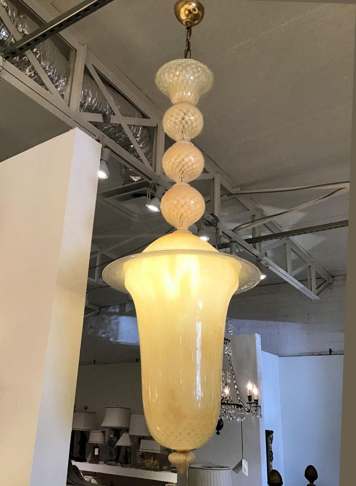 Large-scale Murano glass mid-century modern lantern or chandelier.
Neoclassical style . By Seguso, Italy 1960s.
The Mid-century Murano glass lantern has a golden yellow or Beige color.
The glass work technique is called Balloton, consisting in air