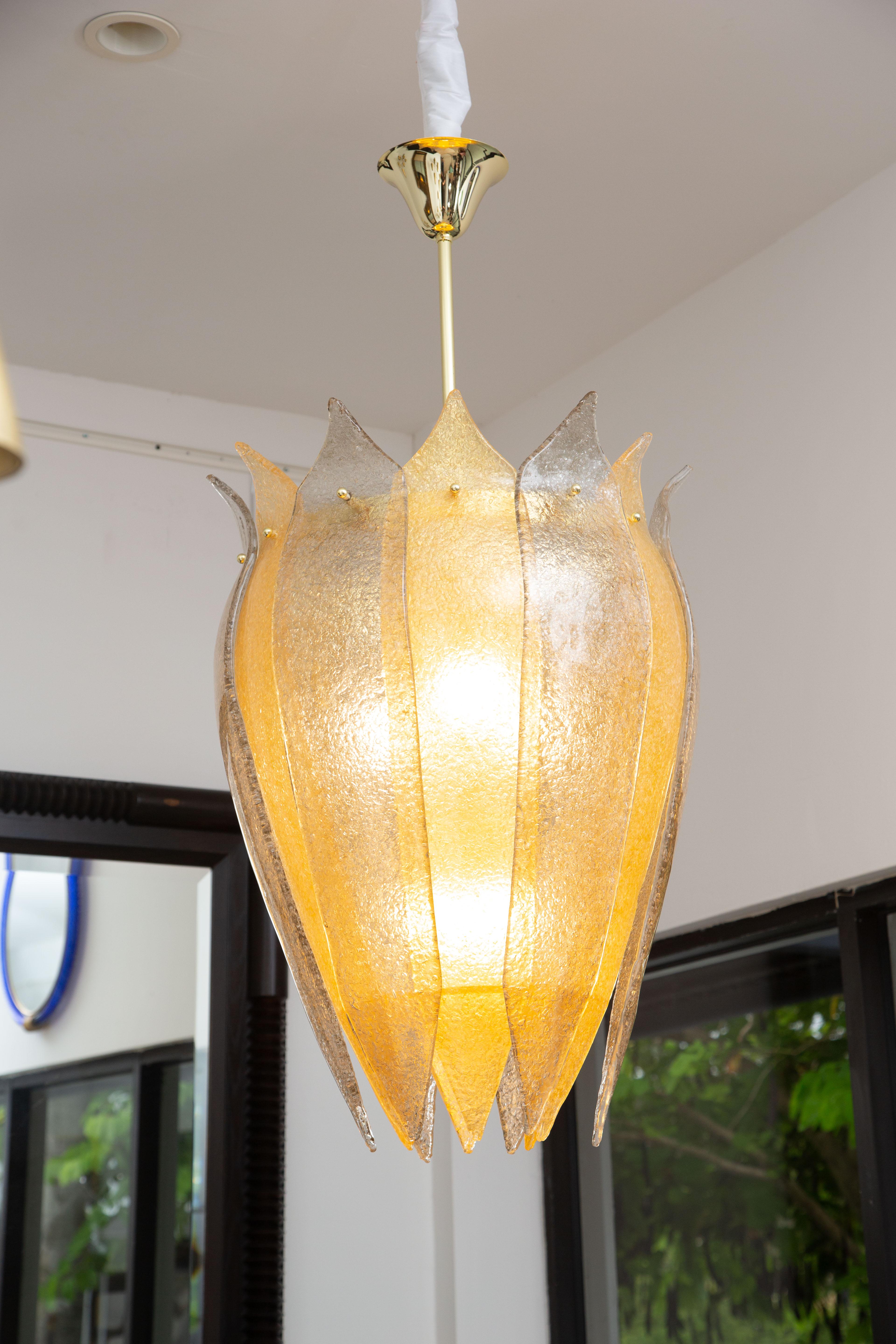 Murano glass lantern or cesendello, in stock
Curved form “graniglia” hand blown glass leaves in gold and smoked
Silhouette is inspired by the ancient street lanterns of Venice
Brass structure with a 48