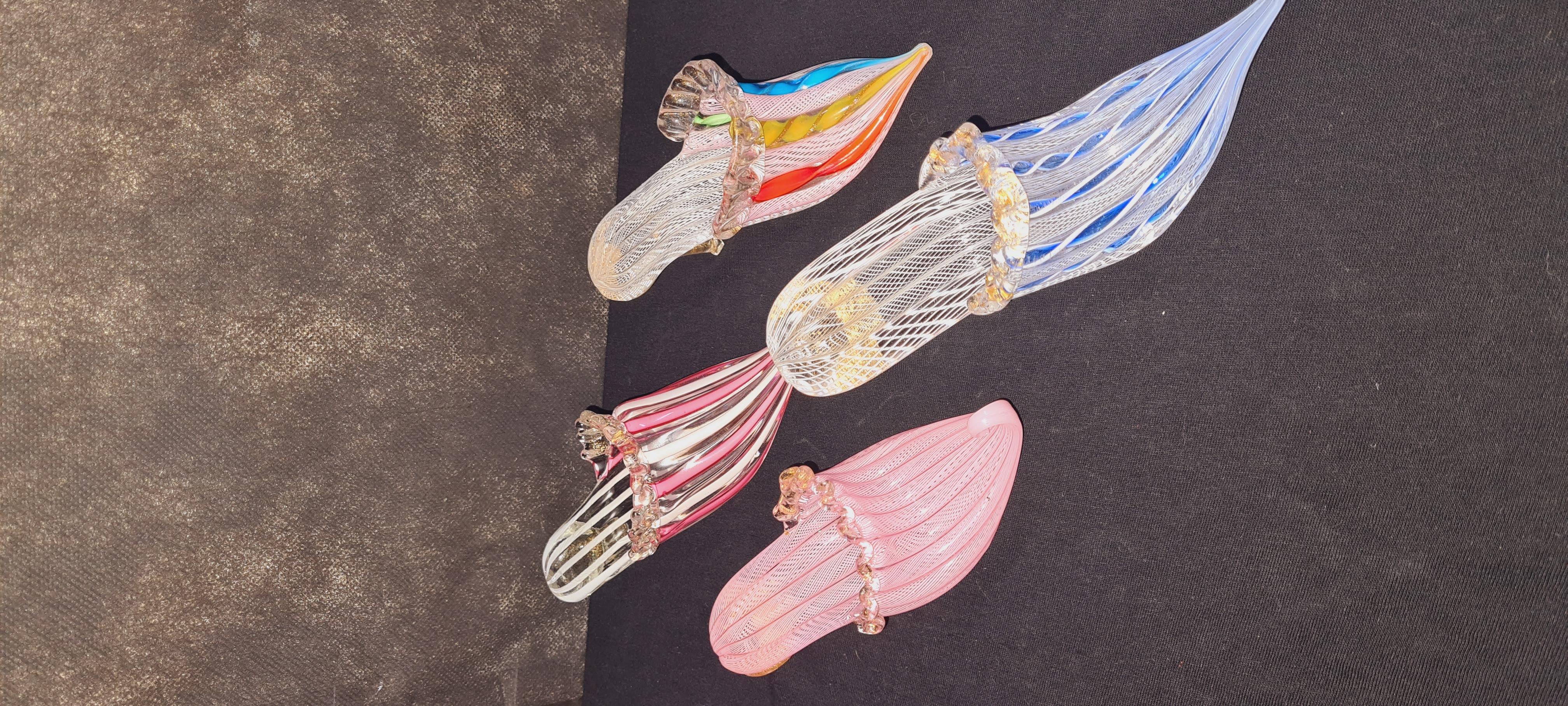 Set of four murano glass latticino ribbon slippers with gold leaf, attributed to Fratelli Toso; years 1960-1969. In excellent condition.