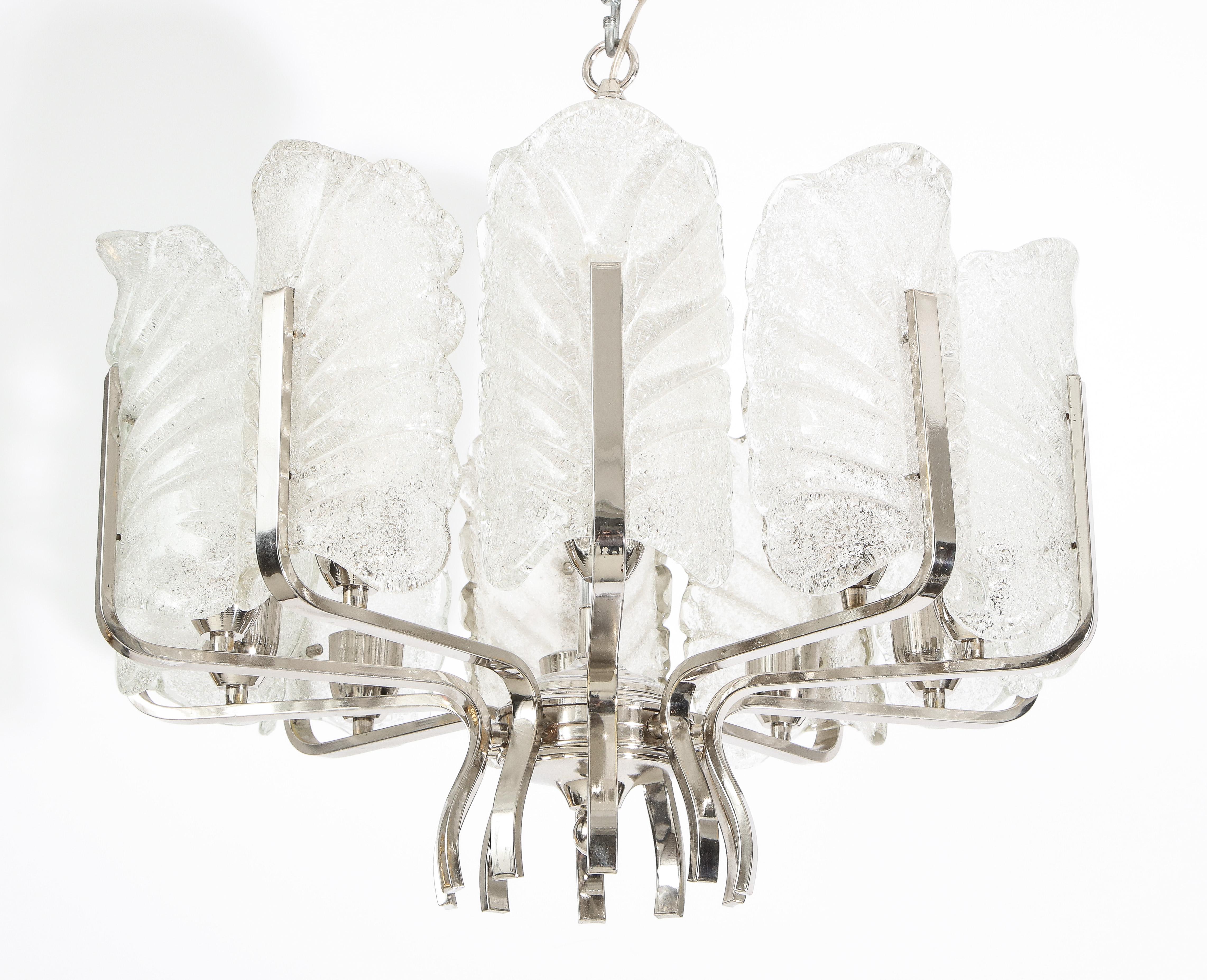 Elegant Murano glass leaf chandelier.
The polished chrome frame supports ten textured frosted Murano glass leaves each illuminated
by there own light source which have been newly rewired for the US with standard size light sockets.
Maximum 25