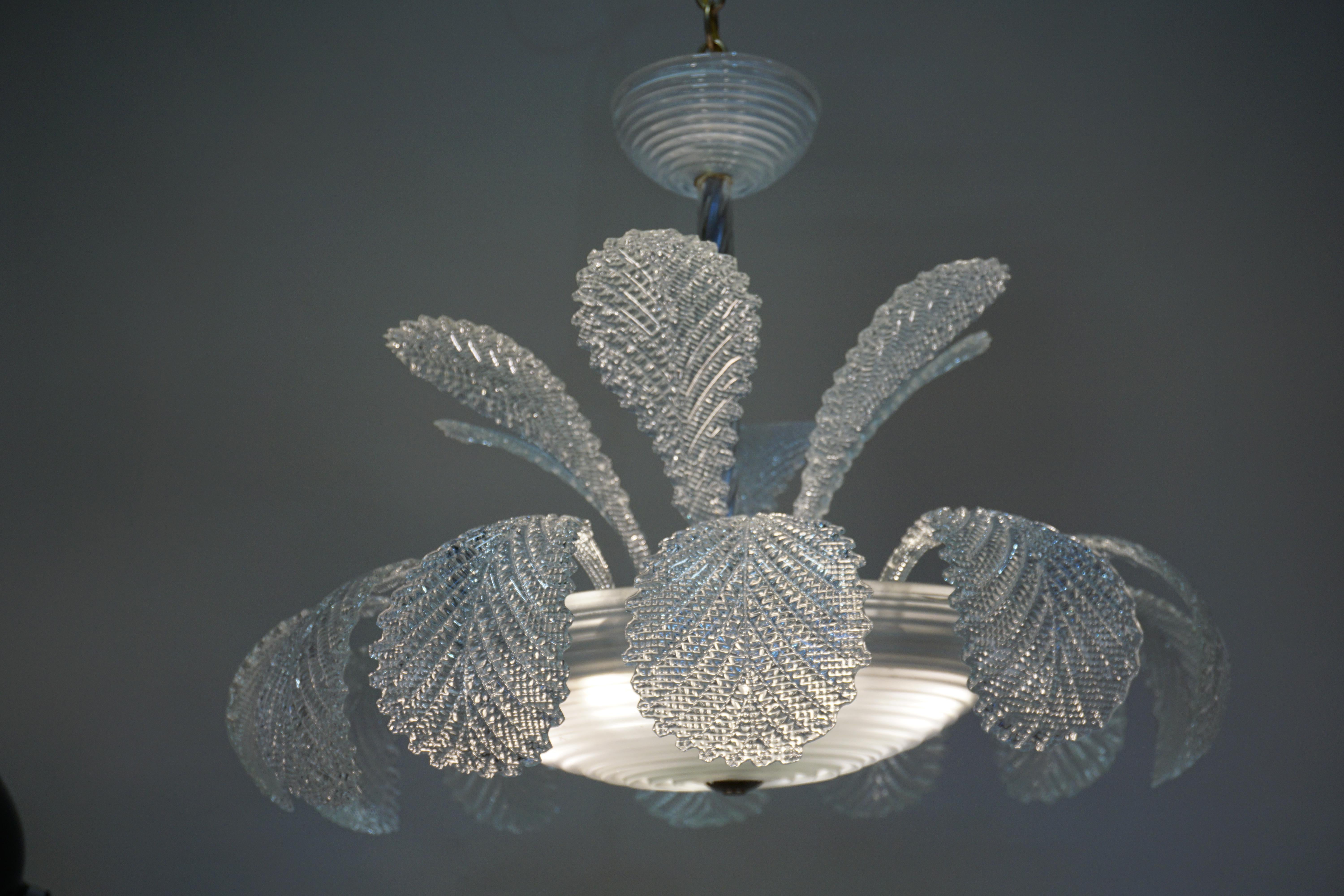 Italian blown glass chandelier with eighteen large glass leaf and large center glass dish.
Six lights 60 watt each.
This chandelier has a height of 44