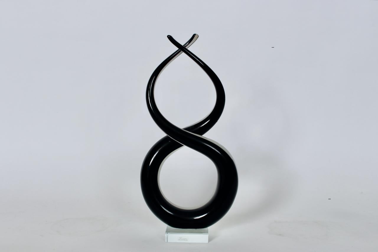 Vintage Murano Glass Abstract Free From, Swirl Black & White Sculpture. Featuring hand blown, curved, figure eight shape with twist top in Black, White and Transparent Murano glass, atop a balanced clear 3D glass base. Small footprint. Original.