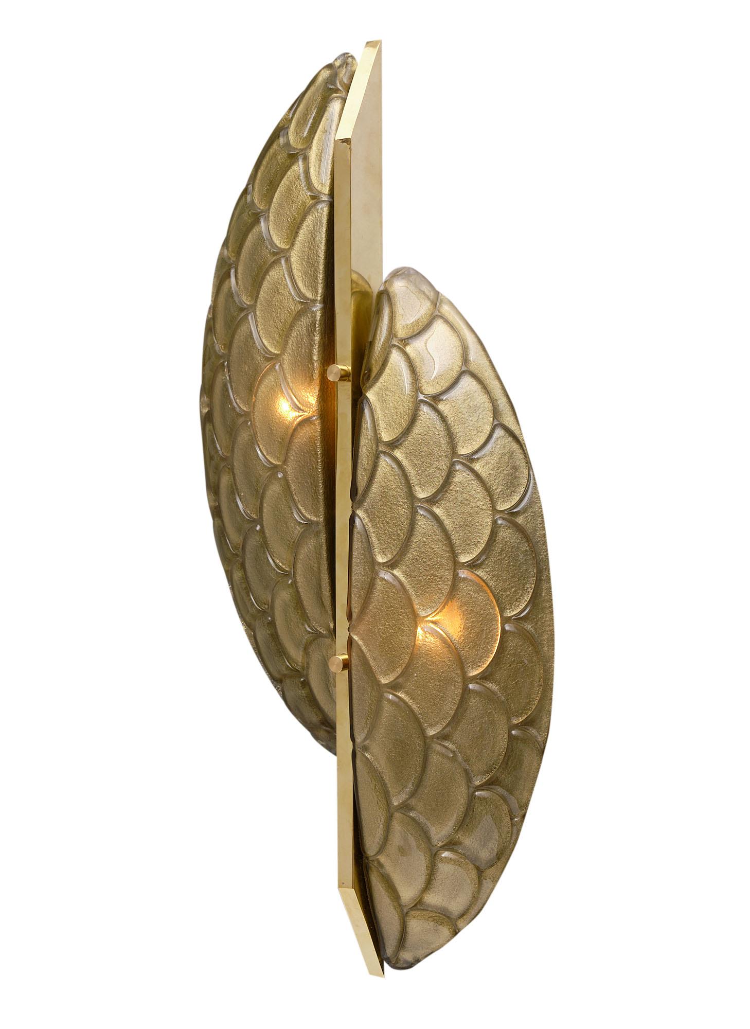 Pair of sconces from the island of Murano in Italy. Each features two stylized hand-blown glass half-moons facing each other joined by a solid brass structure. They have been newly wired to fit US standards.