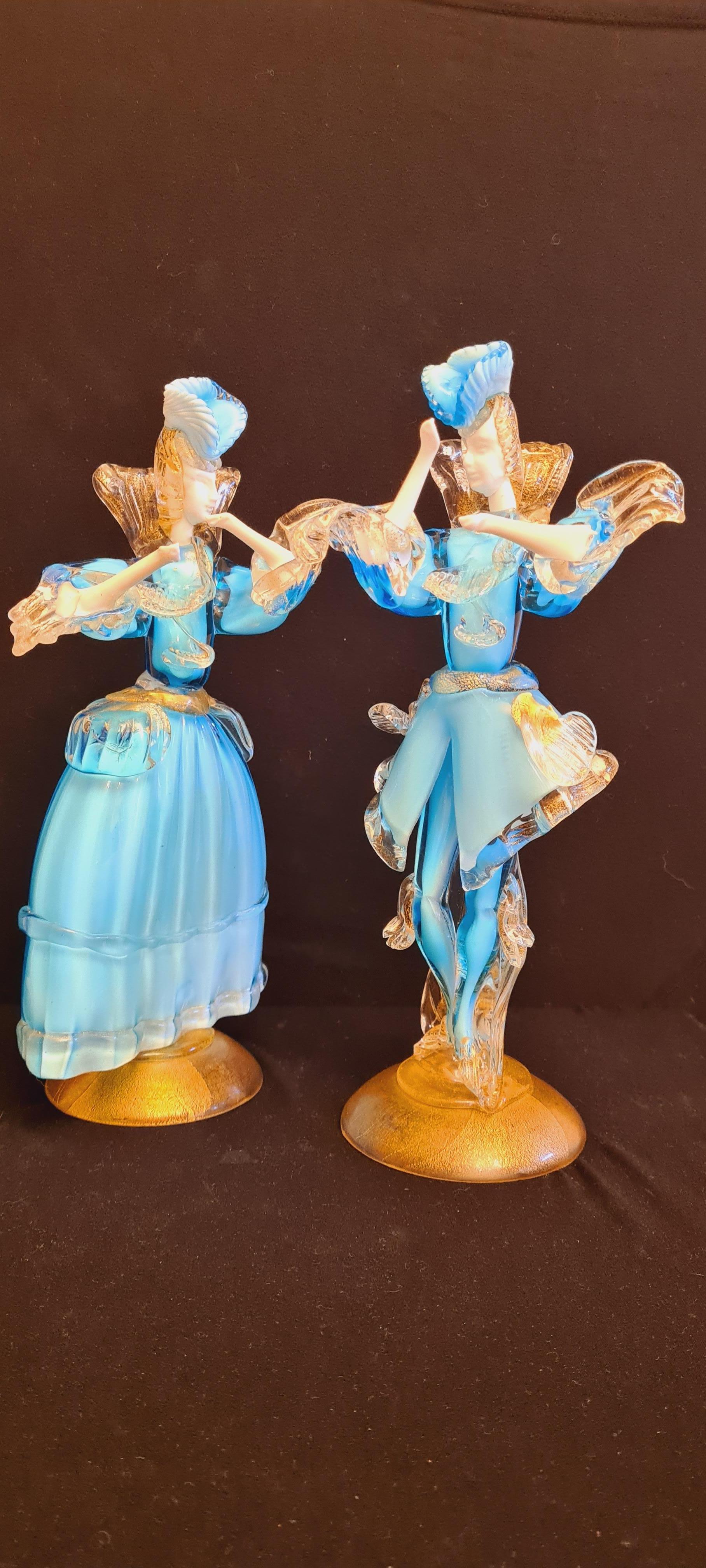 Beautiful Murano glass blue opaline dancers with gold leaf, attributed to Aureliano Toso; years 1950-1960. In excellent condition.