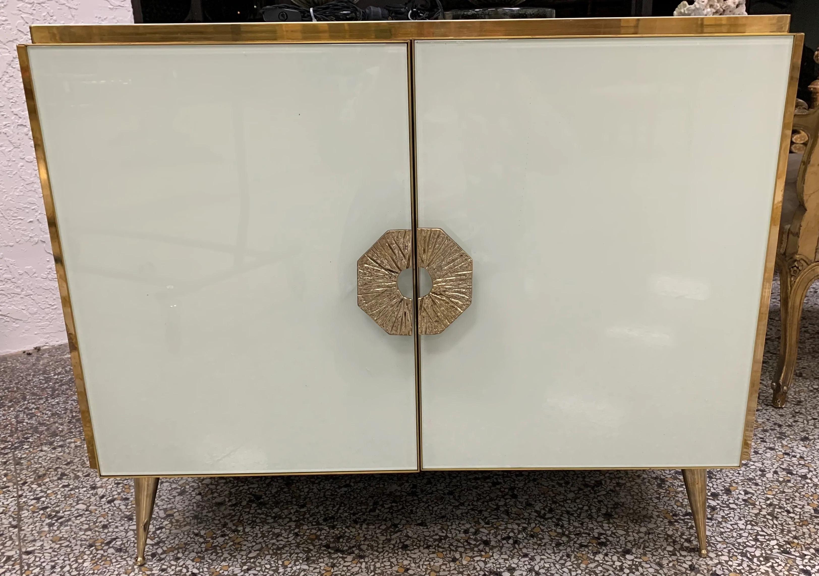 What a gorgeous pair of modern Murano Italian glass and brass side cabinets or sideboards. This beautiful pair has been carefully handblown and crafted in Murano, Italy. These cabinets feature brass legs, handles, edges and brass details throughout