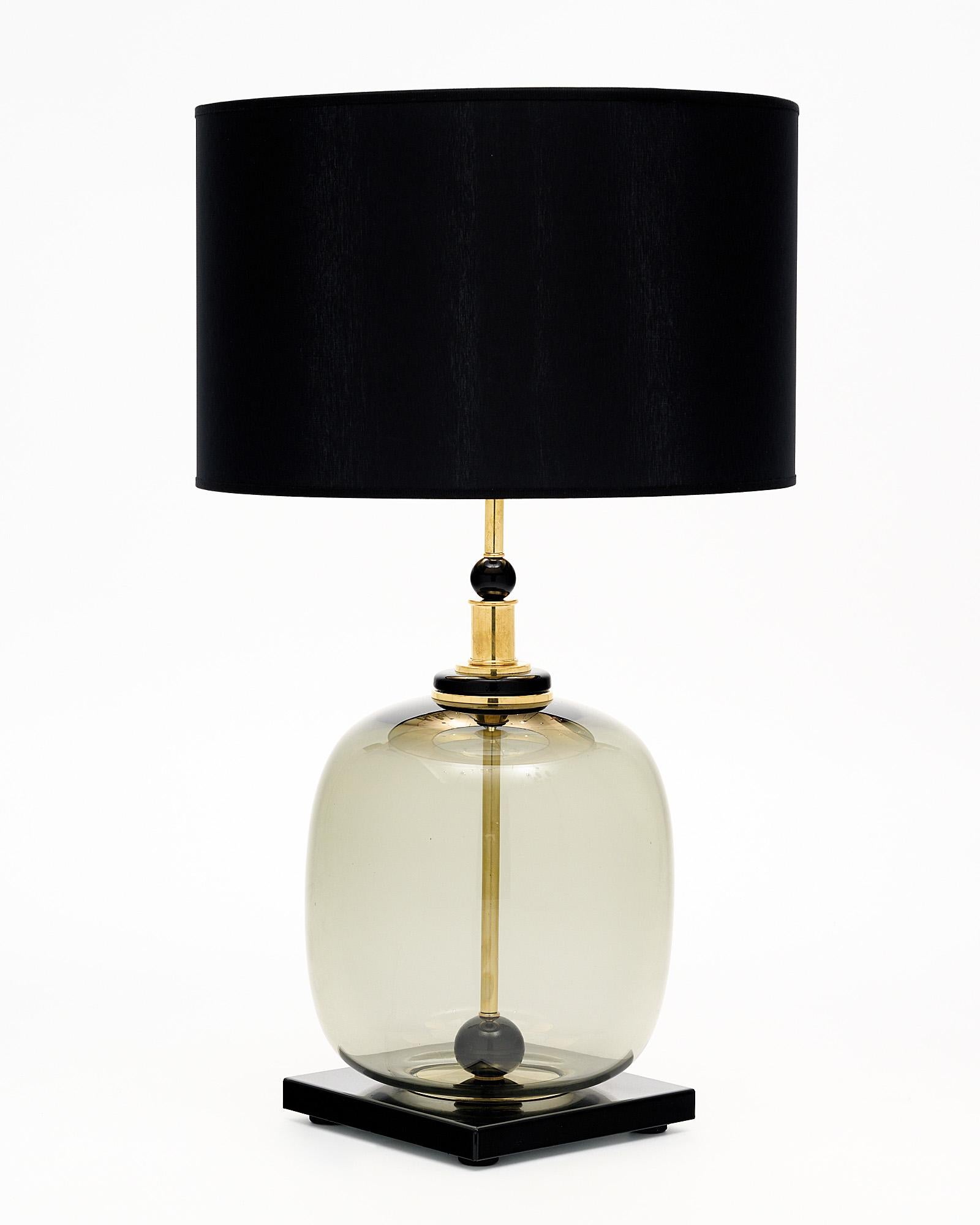 Pair of hand-blown Murano glass lamps featuring unique glass components on a brass structure. In the style of iconic Italian designer Ettore Sotsass. We love the geometric forms and strong impact this pair brings to a space. We love the contrast of