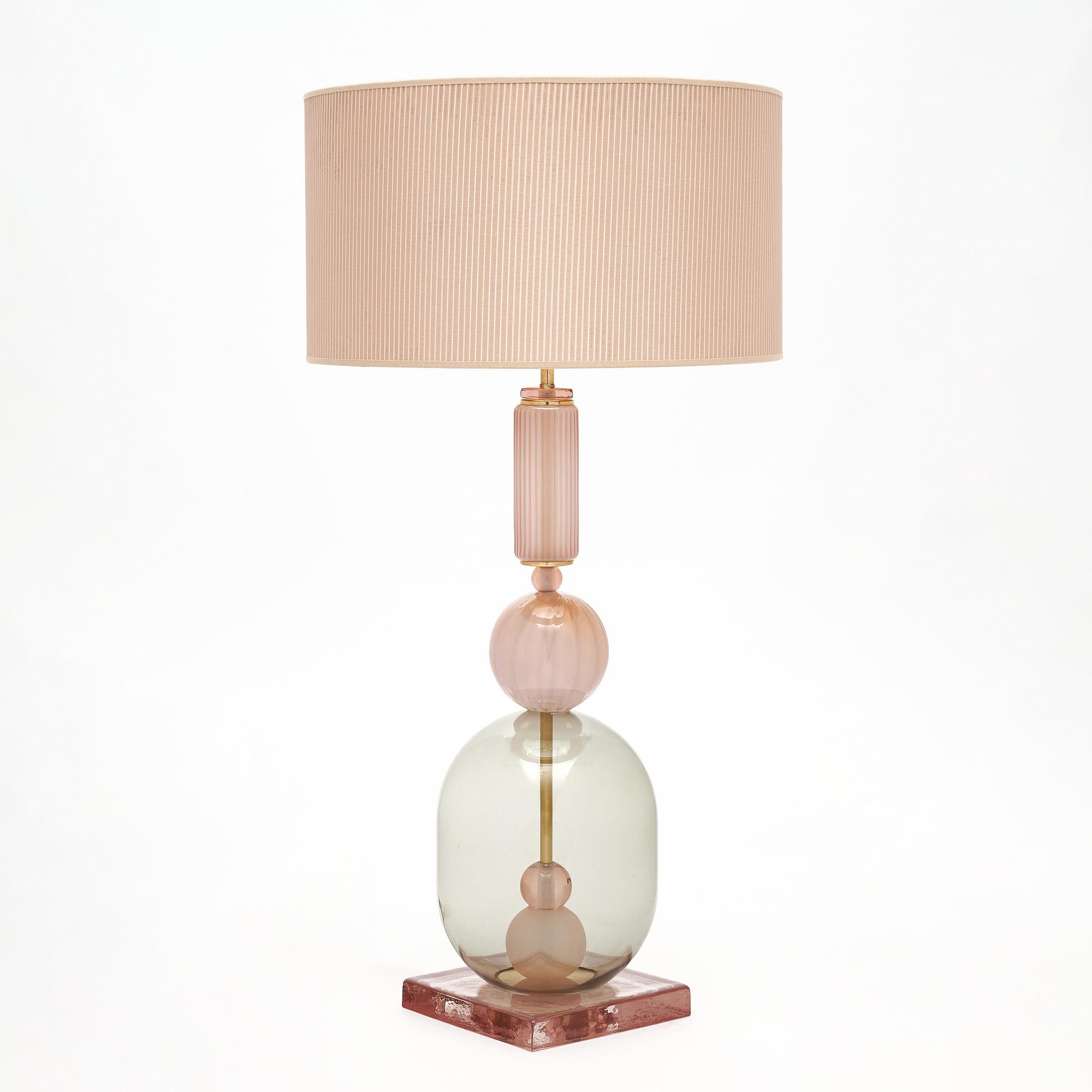 Pair of hand-blown Murano glass lamps featuring unique glass components supported on a brass structure. In the style of iconic Italian designer Ettore Sotsass. We love the pink tone to the glass and the geometric forms that have a strong impact to a