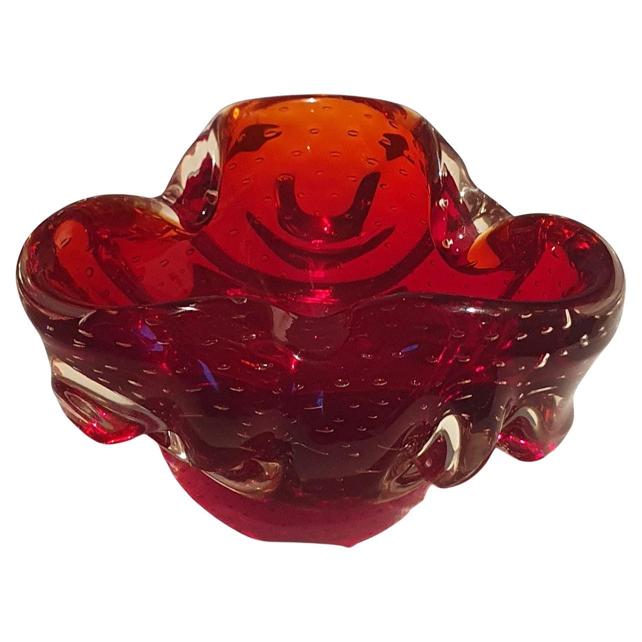 This stunning ruby Red vintage Venetian Murano Glass dish has undulating curled edges, Rosette details and controlled Bubbles and looks stunning under direct light

This vintage red glass dish is a beautiful addition to any collection. The dish