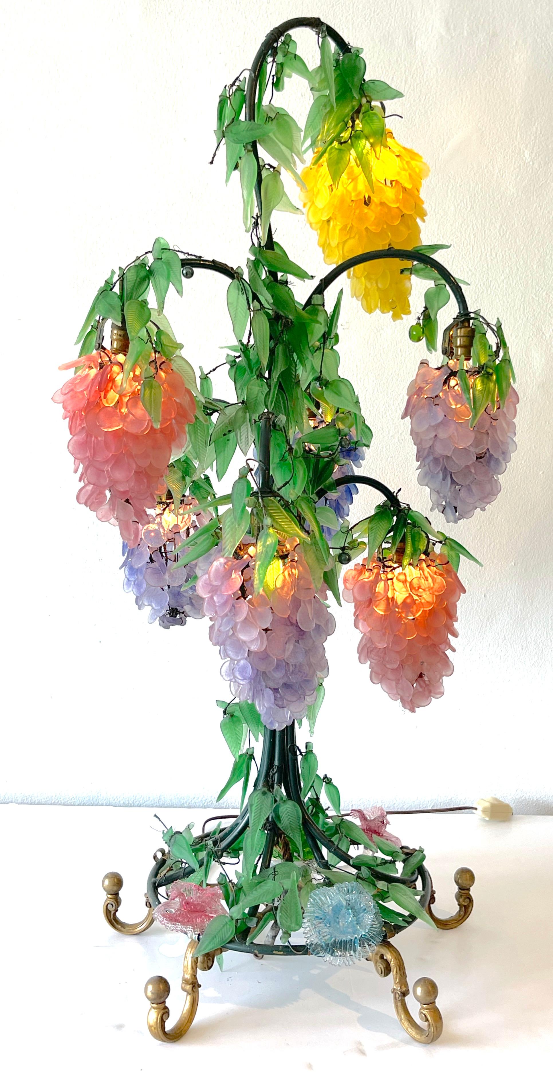 Murano Glass Multi-Colored Wisteria 7 Tiered table lamp, 
Italy, Circa 1950s
A monumental masterwork of the Murano glass works, most often these intricate lamps are clusters of fruits. 
This version standing 40-inches tall with graduating colorful