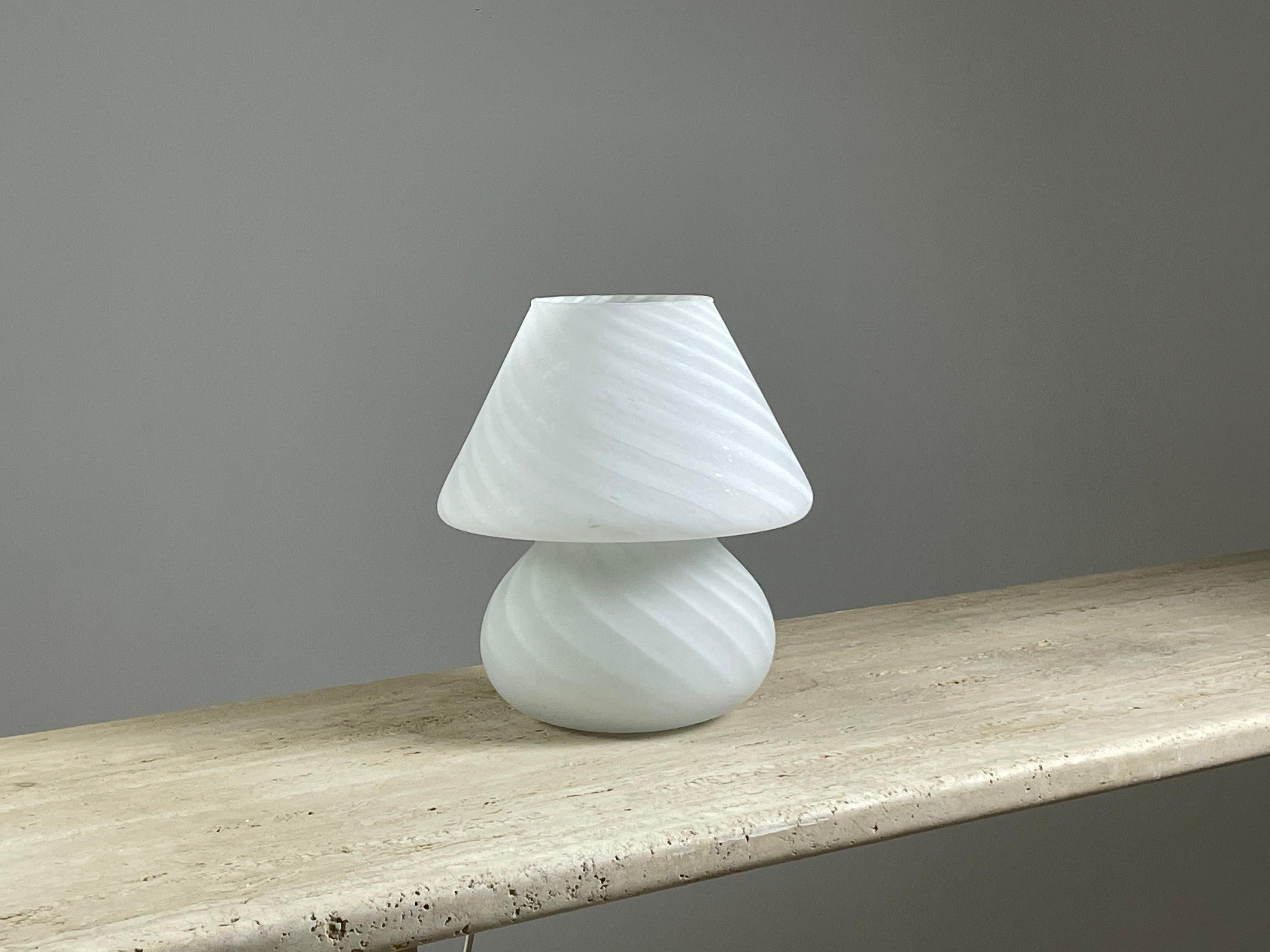 Lampe de table en forme de champignon en verre de Murano datant des années 1970. Très belle lumière et élégance pour cette lampe de grande qualité. Bon état général (photos) Dimensions : h27 cm diamètre 24 cm.